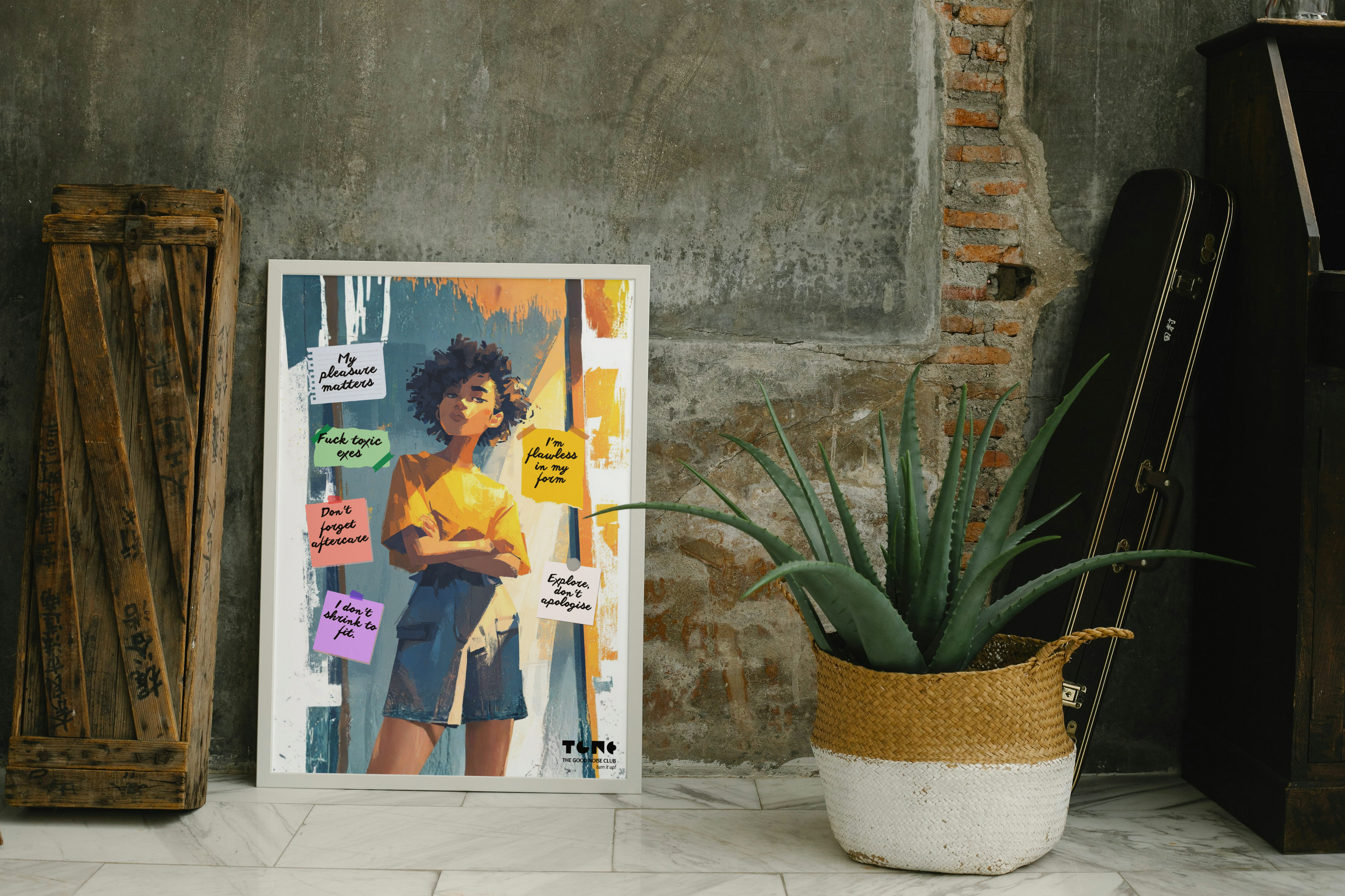 Poster of a person with colorful text overlays in a room with a plant and wooden crate.