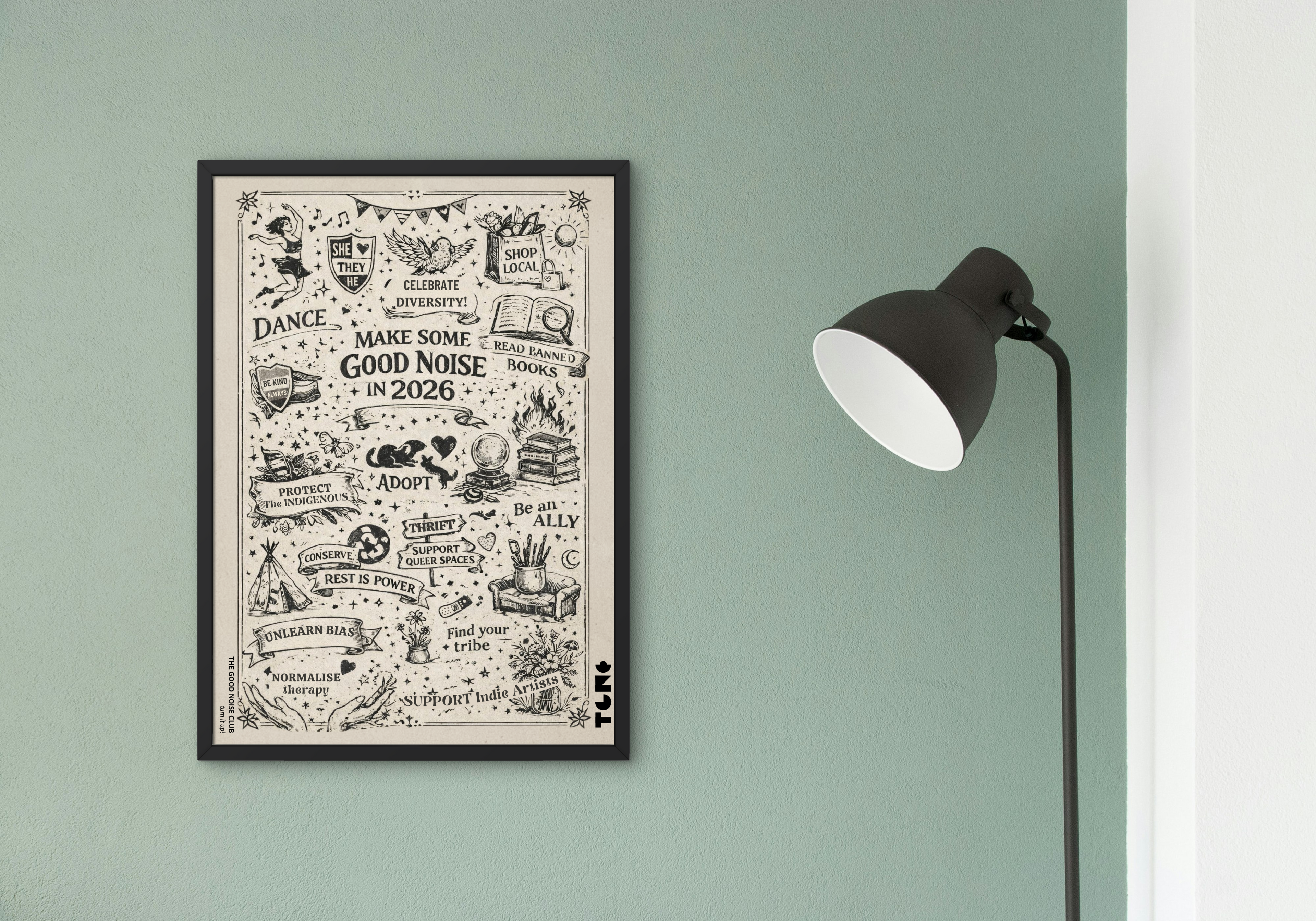 Framed artwork on a wall with a lamp to the right.