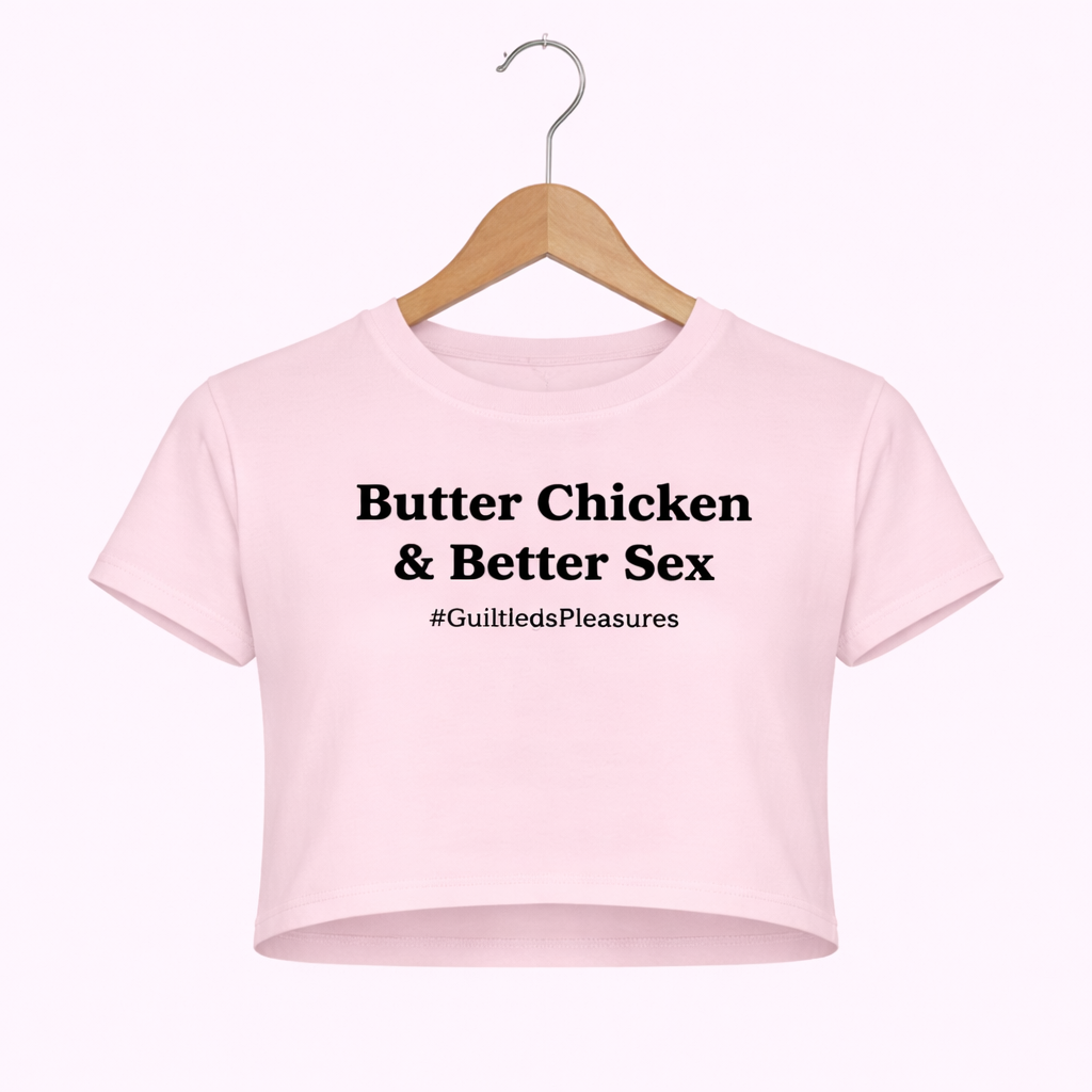 Pink crop top with text on a hanger against a white background