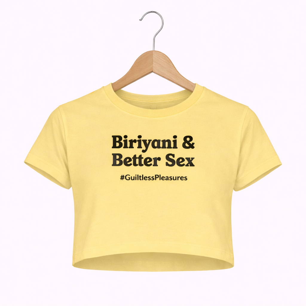 Yellow crop top with text on a hanger against a white background