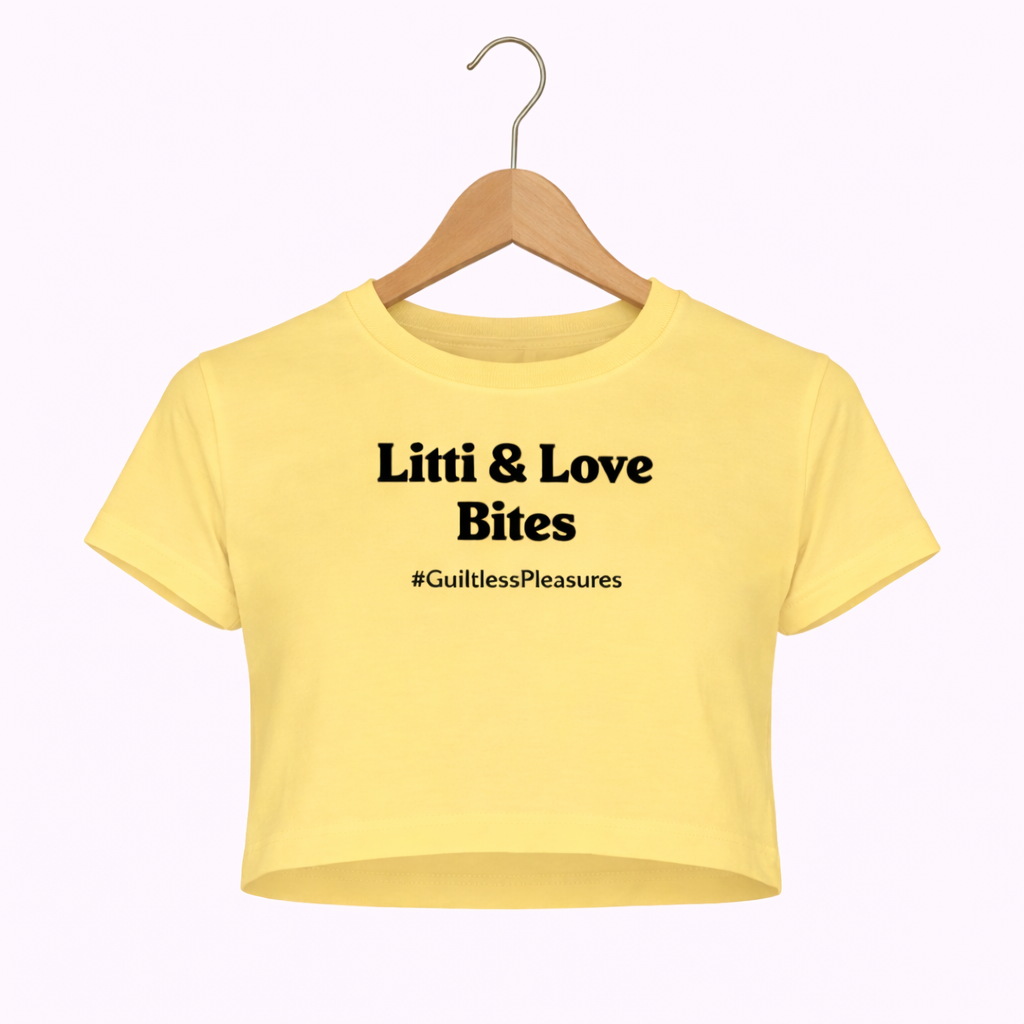 Yellow crop top with text on a hanger against a white background