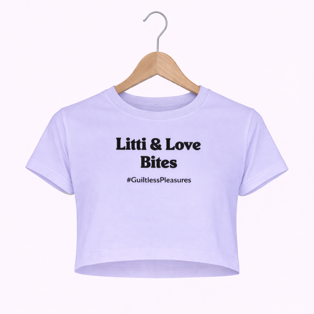 Lavender crop top with text on a hanger against a white background