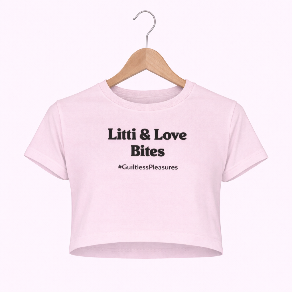 Pink crop top with text on a hanger against a white background