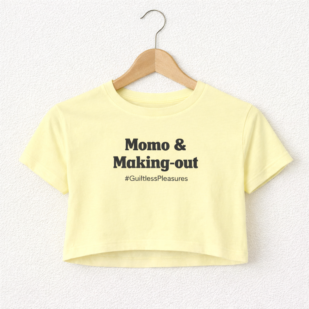 Yellow crop top with text on a hanger against a white background