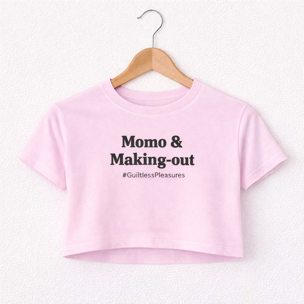 Pink crop top with text on a hanger against a white background