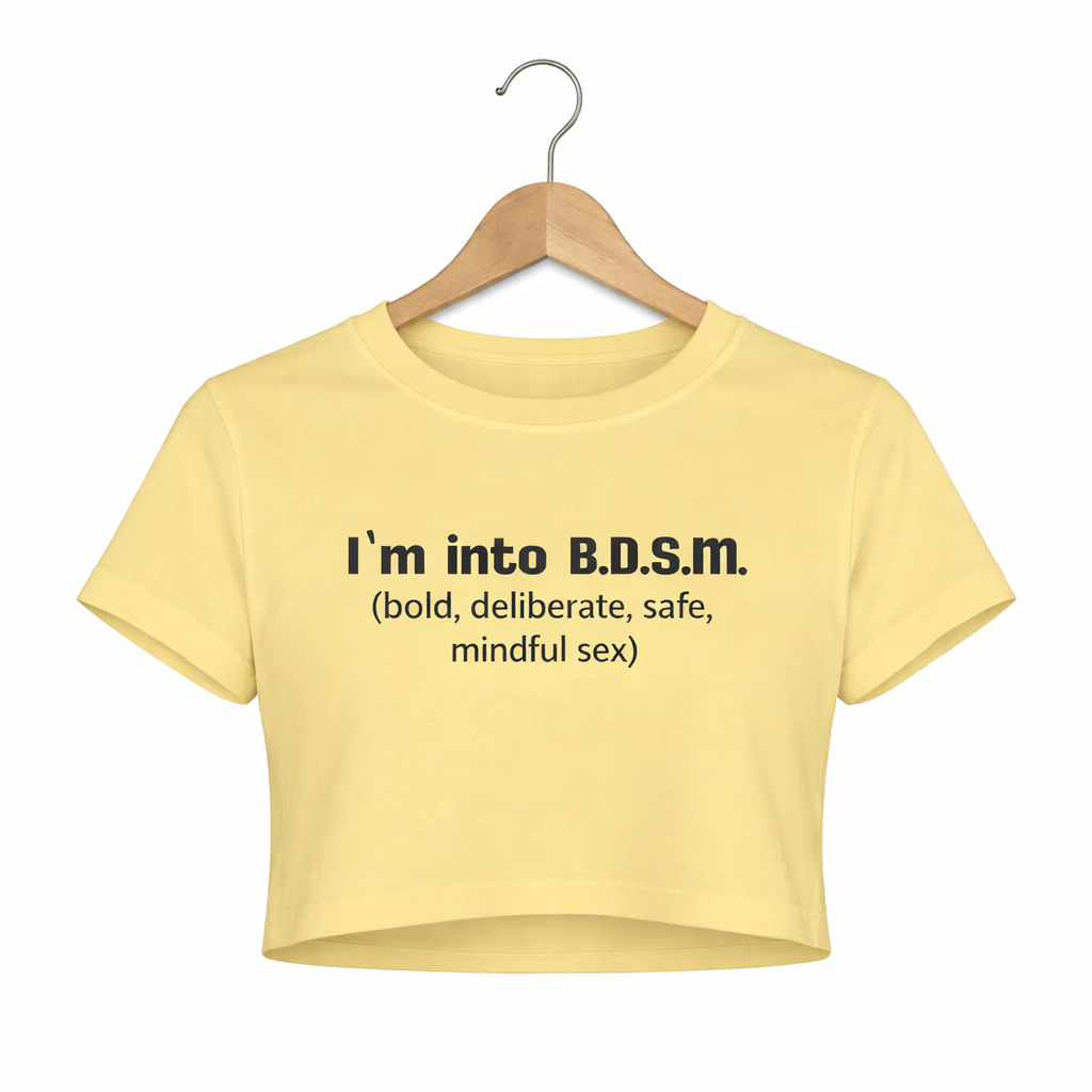 Yellow crop top with text on a hanger against a white background