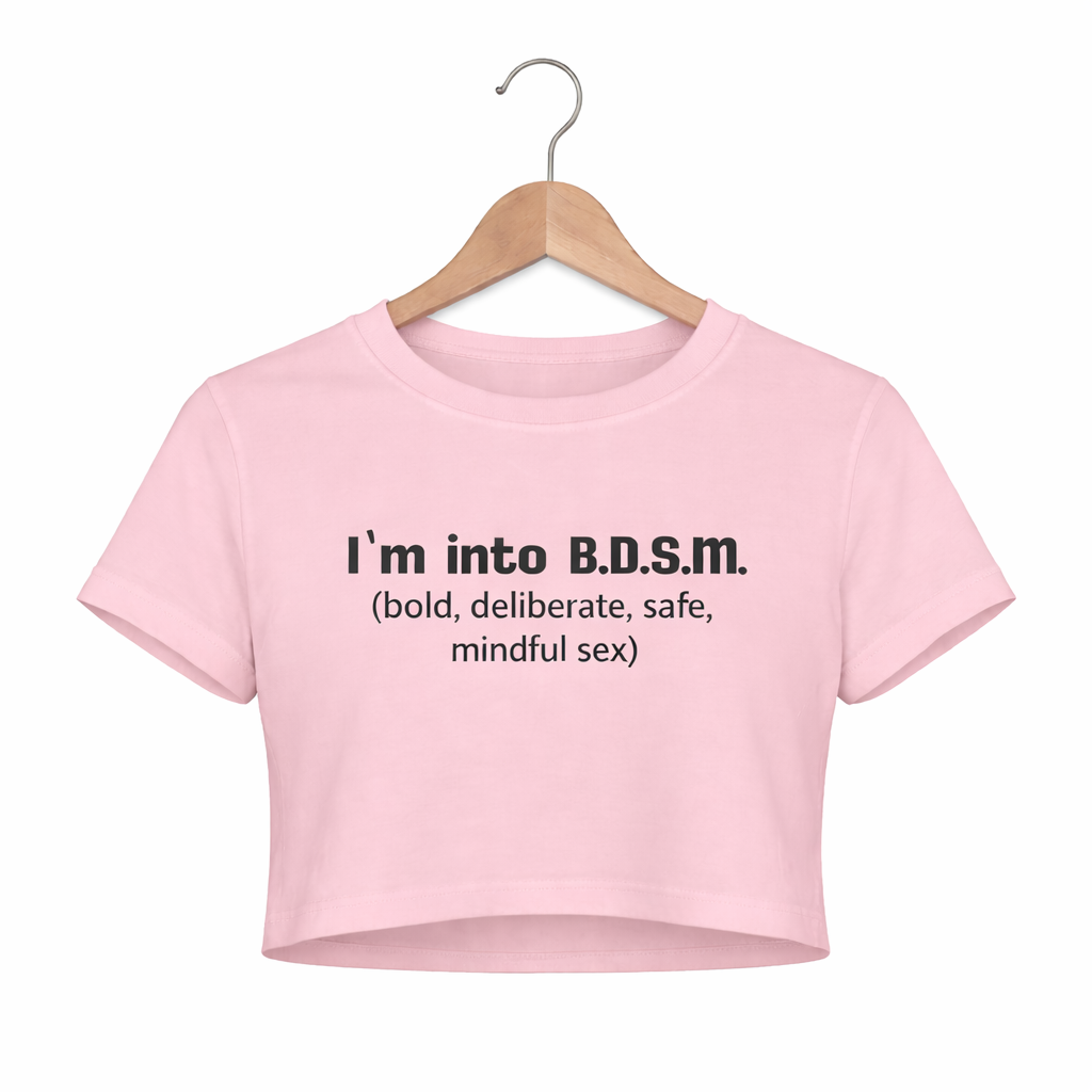 Pink crop top with BDSM text on a hanger against a white background
