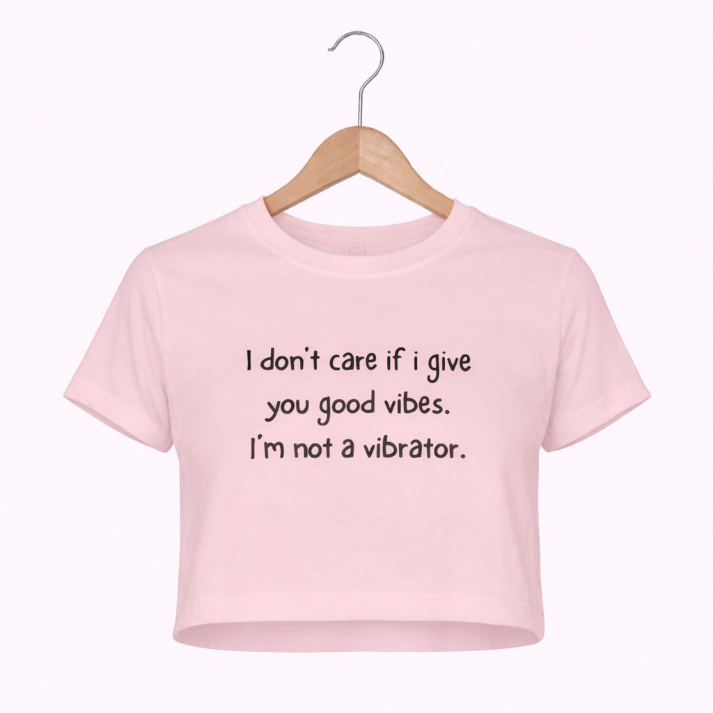 Pink t-shirt with humorous text on a hanger against a white background