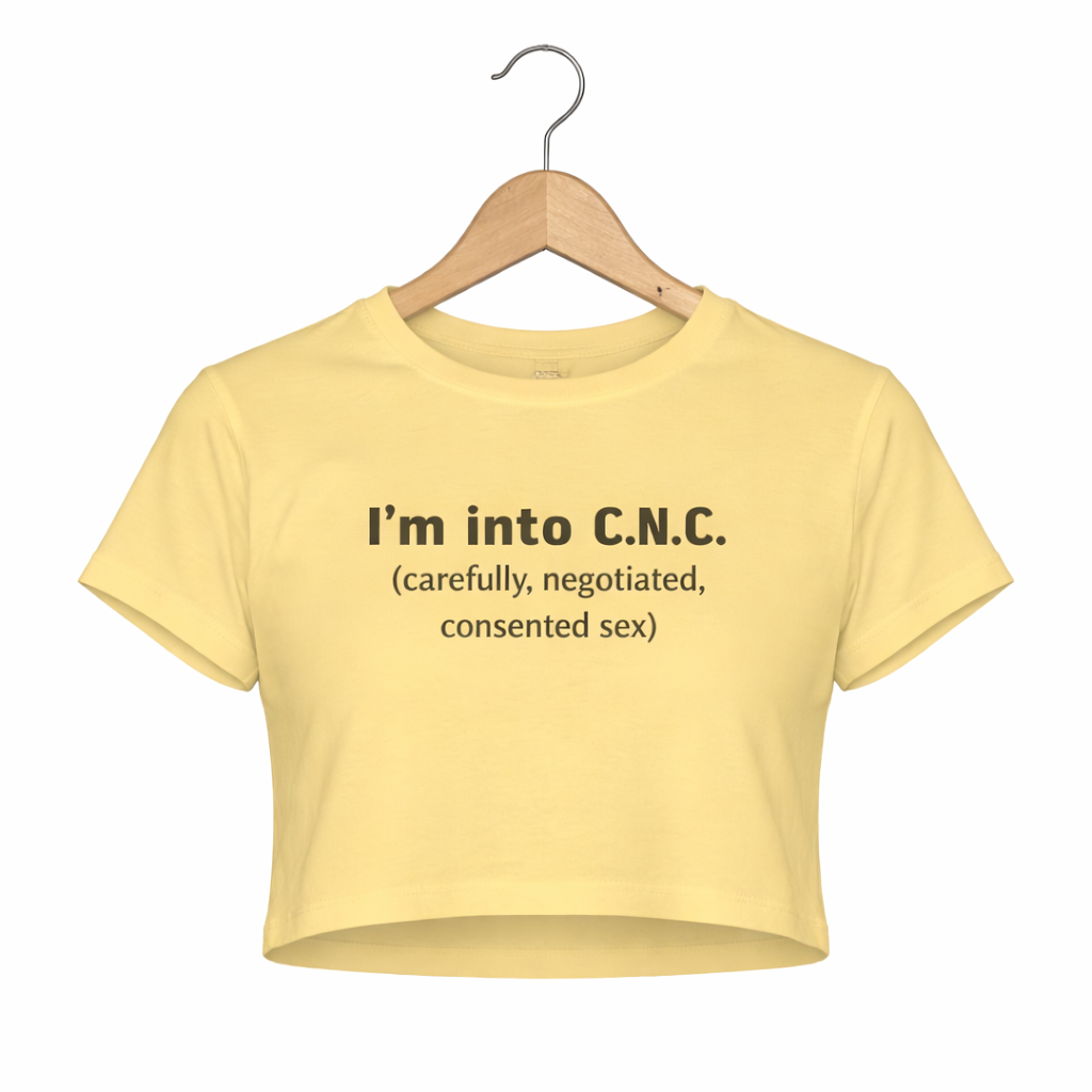 Yellow crop top with text on a hanger against a white background