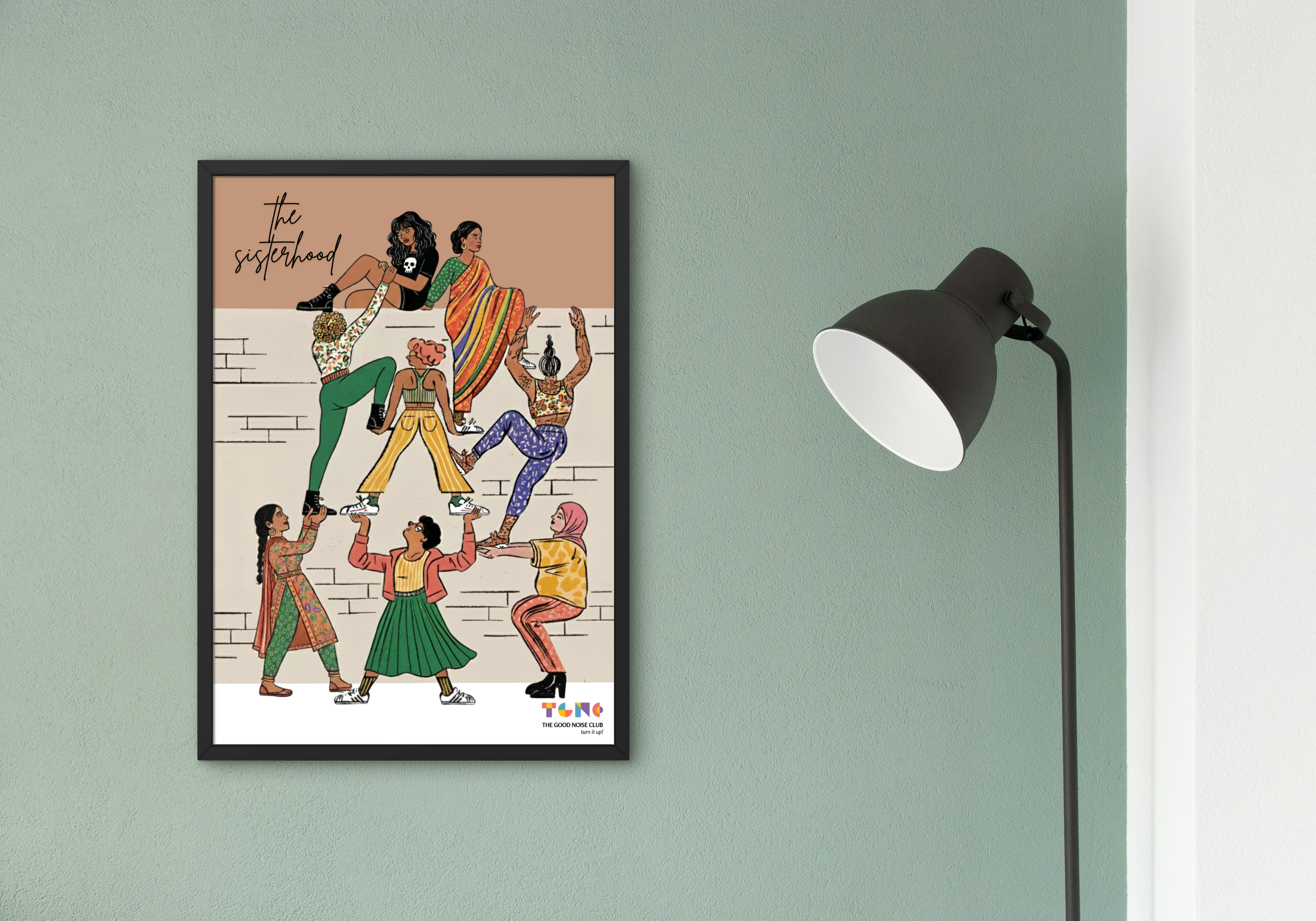 Framed artwork of six women dancing on a wall with a lamp to the right.