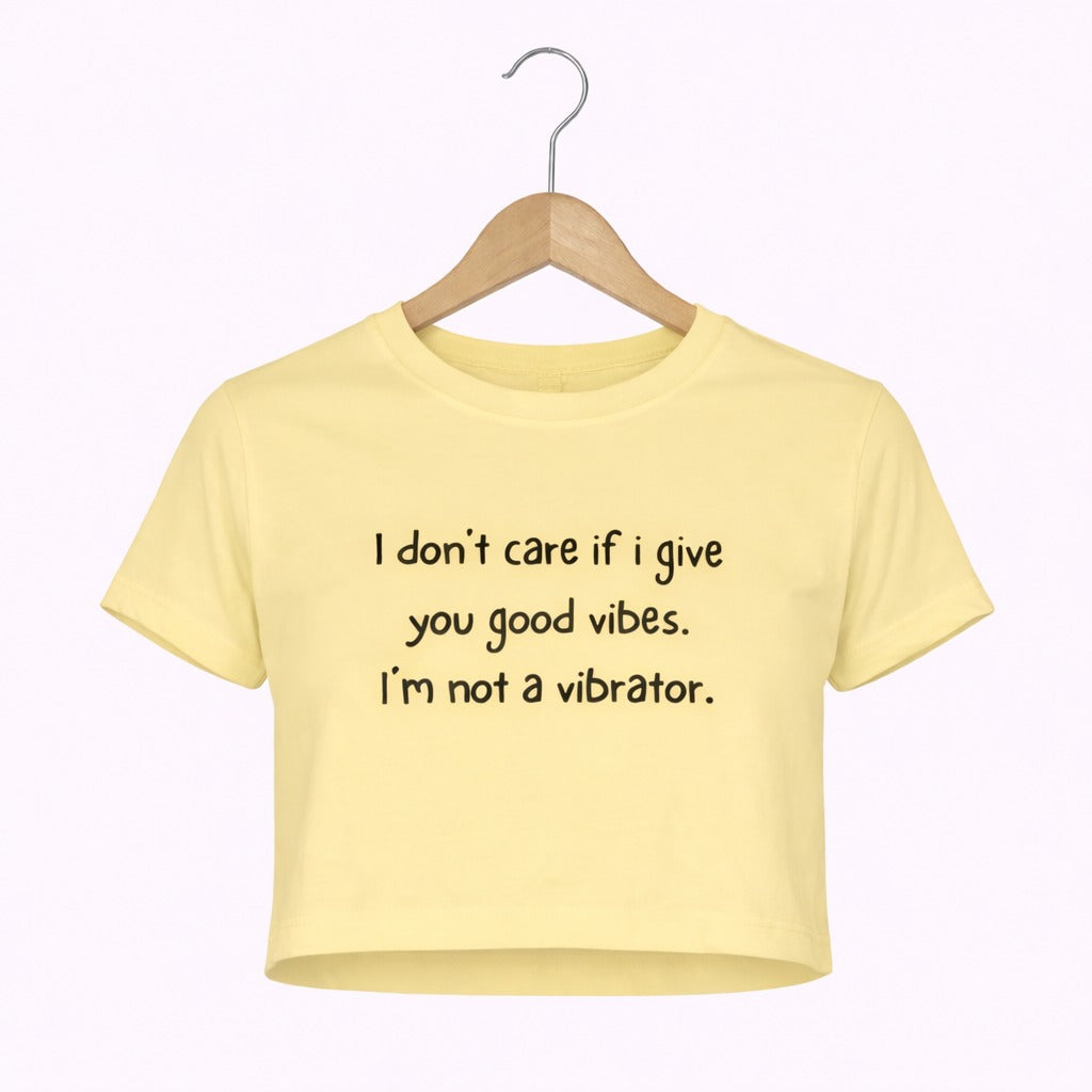 Yellow t-shirt with text on a hanger against a white background