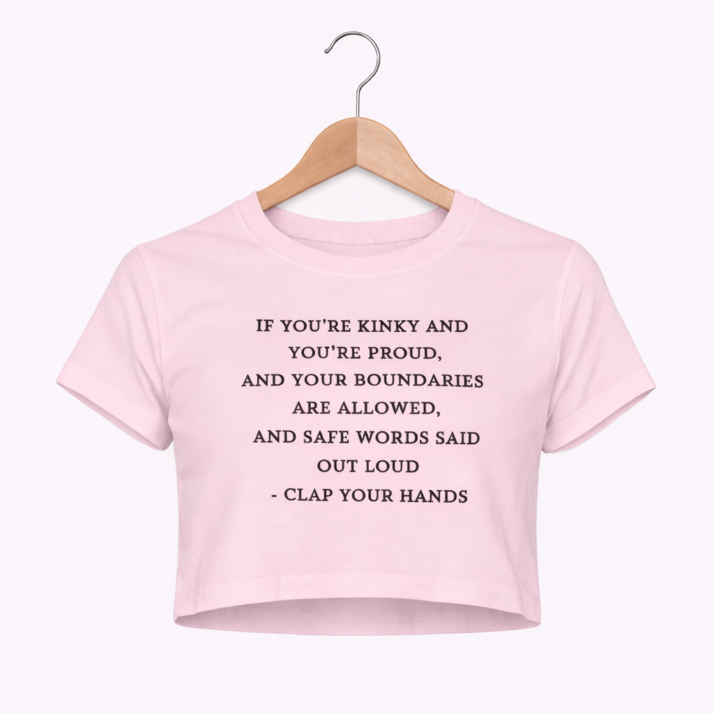 Pink crop top with text on a hanger against a white background