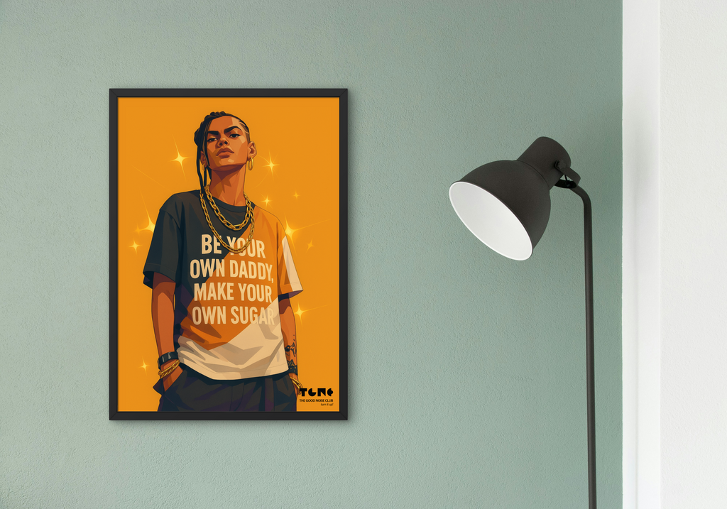 Framed poster of a person with text on an orange background, displayed on a wall next to a lamp.