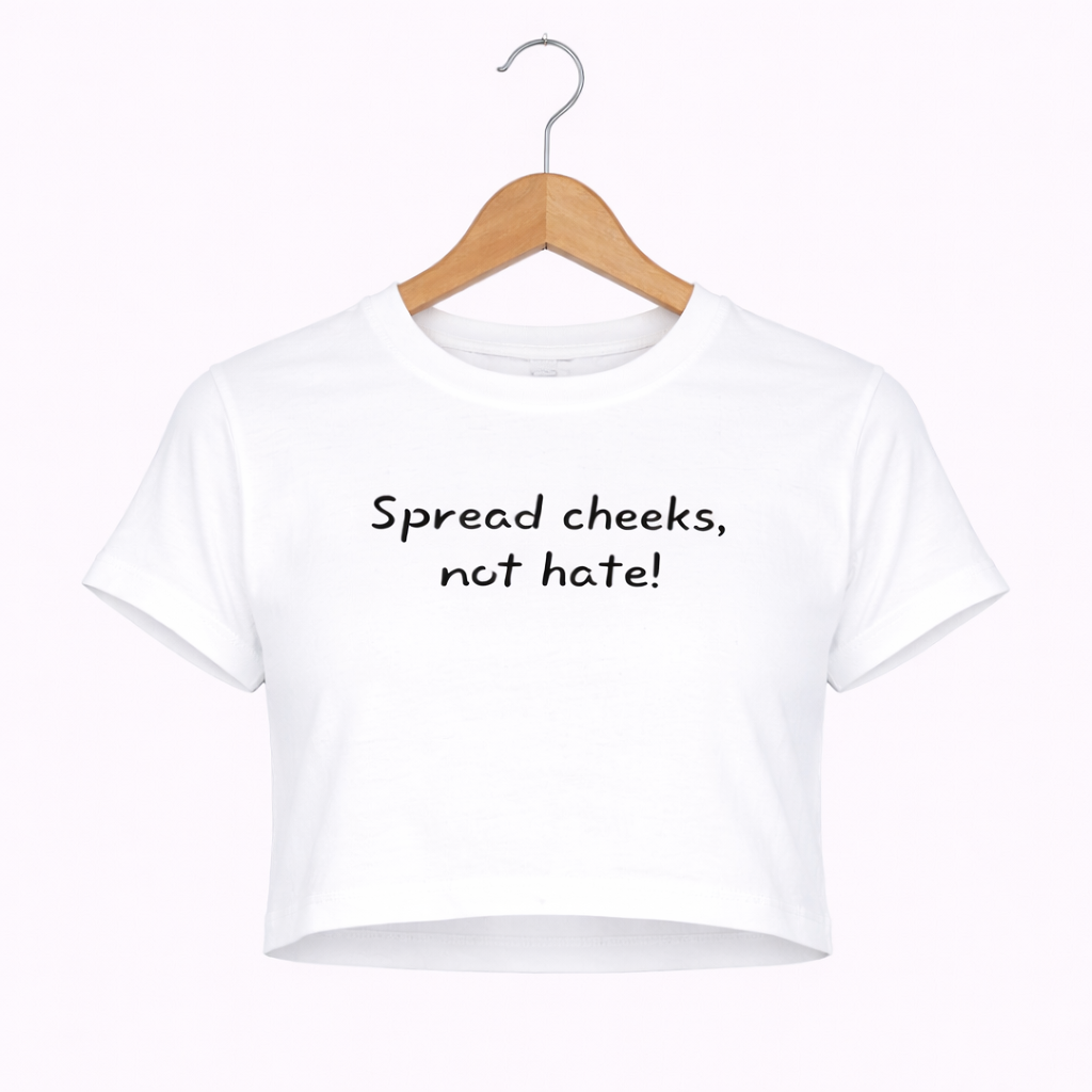 White t-shirt with text 'Spread cheeks, not hate!' on a wooden hanger against a white background