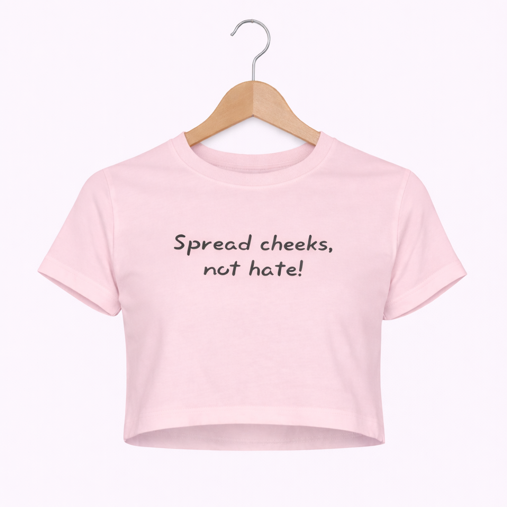 Pink crop top with text 'Spread cheeks, not hate!' on a hanger against a white background