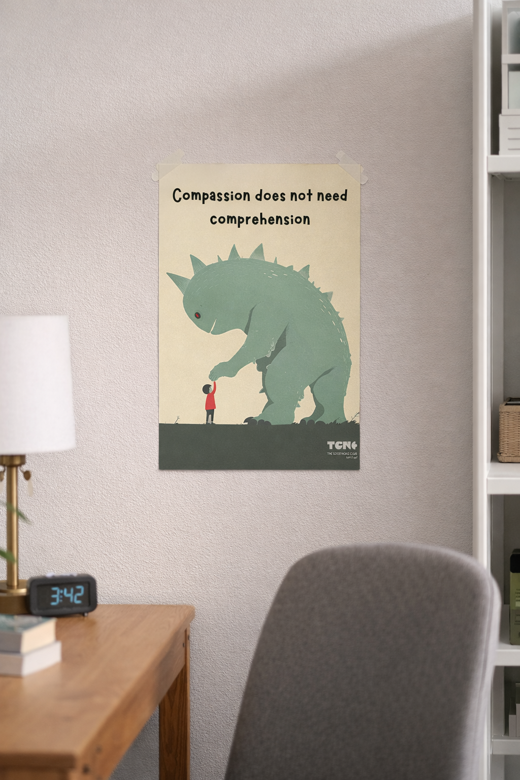 Poster of a dinosaur and a person on a wall above a desk with a lamp and clock.