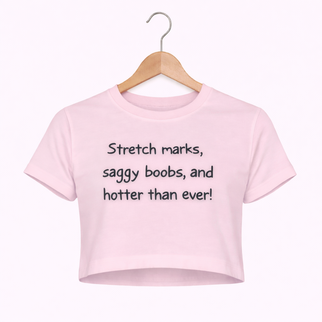 Pink crop top with text on a hanger against a white background