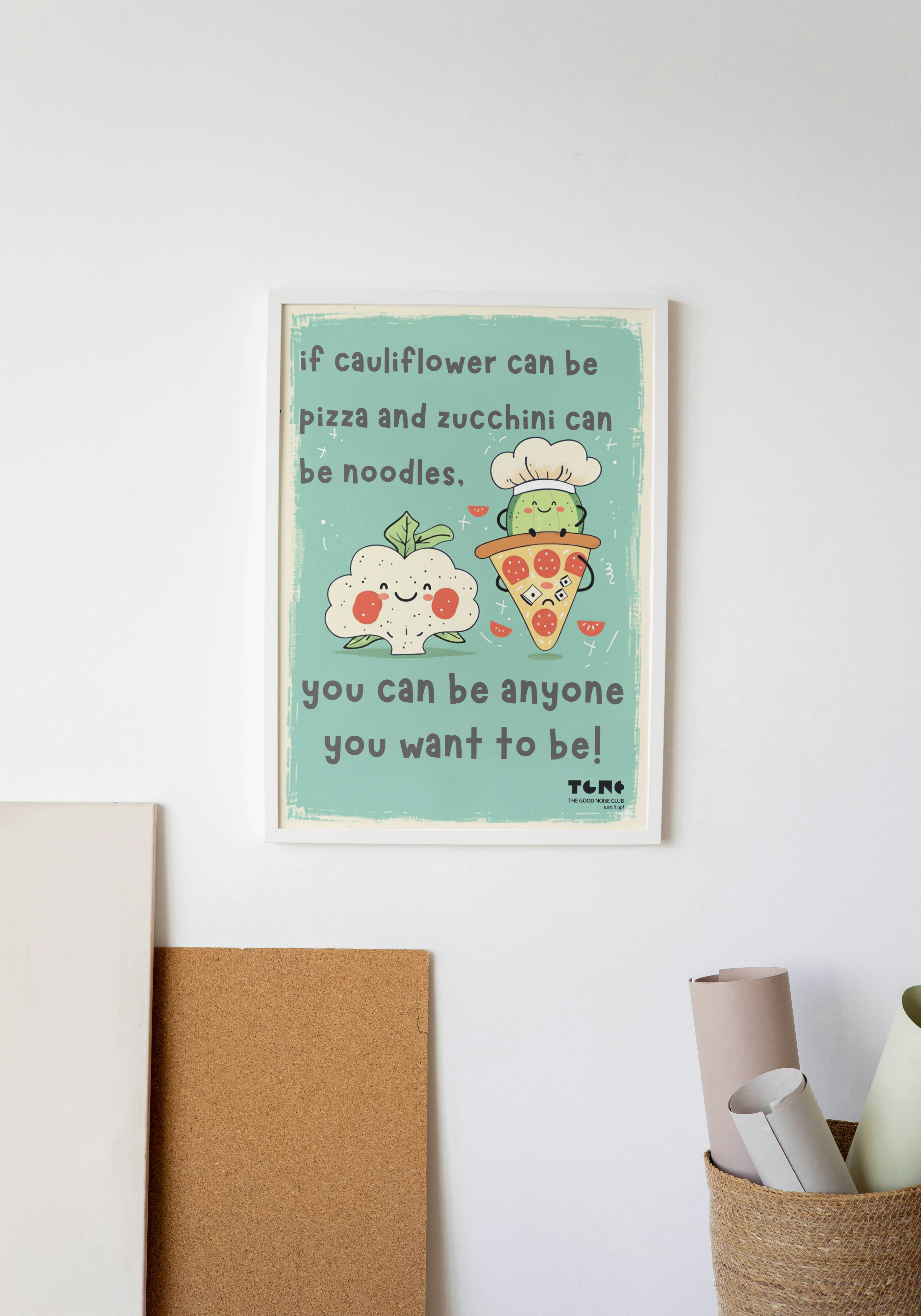 Framed poster with a motivational quote on a wall with decor items below.