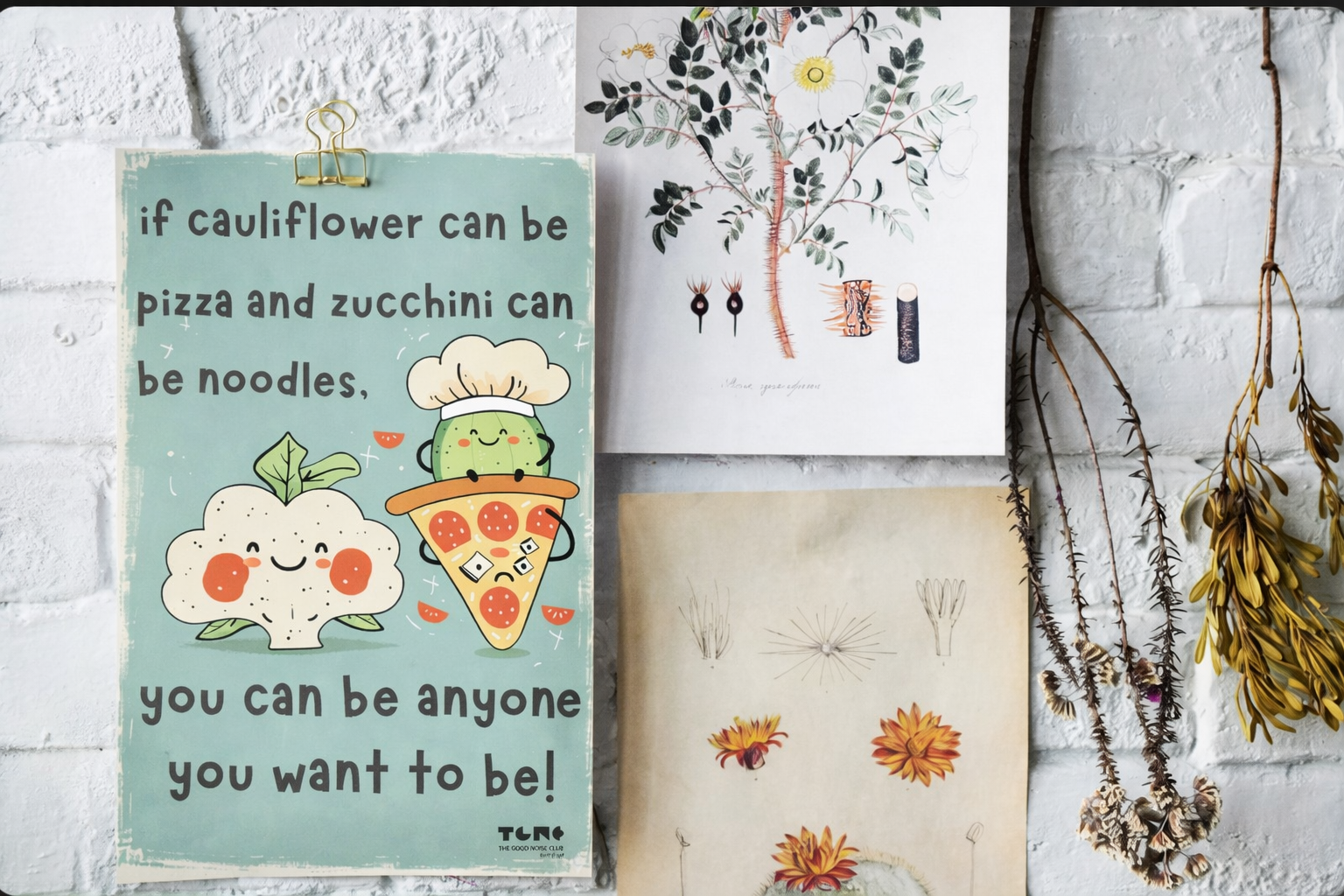 Collage of illustrations on a textured wall with dried plants.