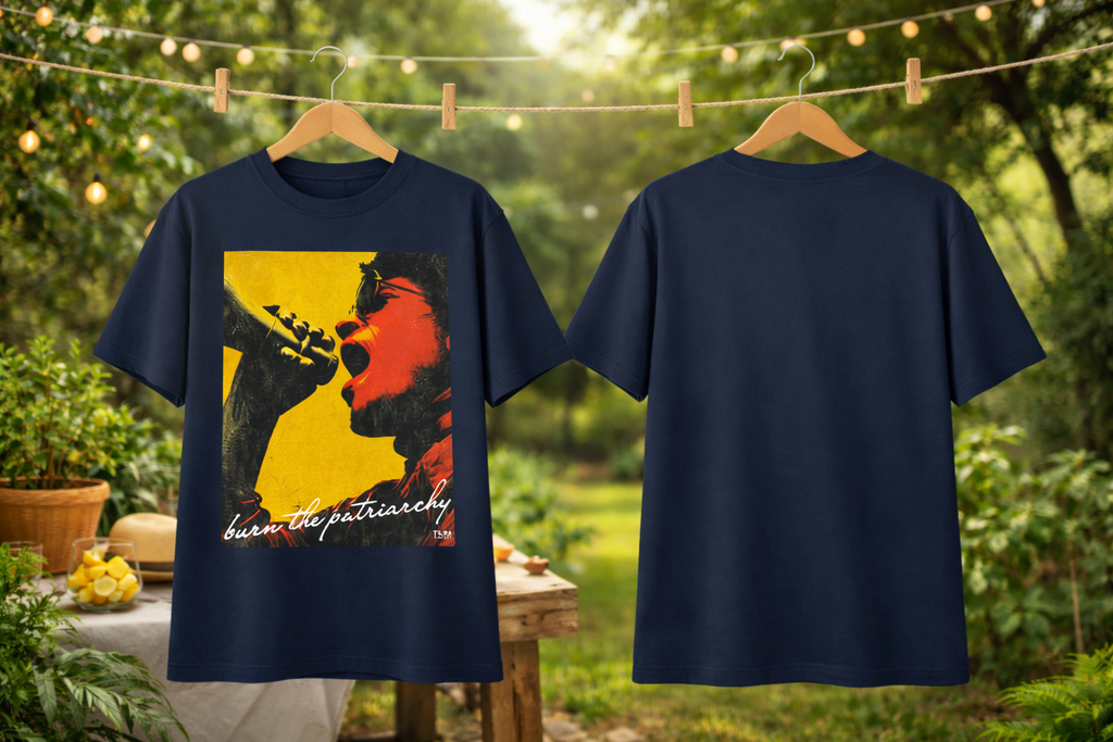 Navy blue t-shirt with graphic design and text on a wooden hanger against a natural background.