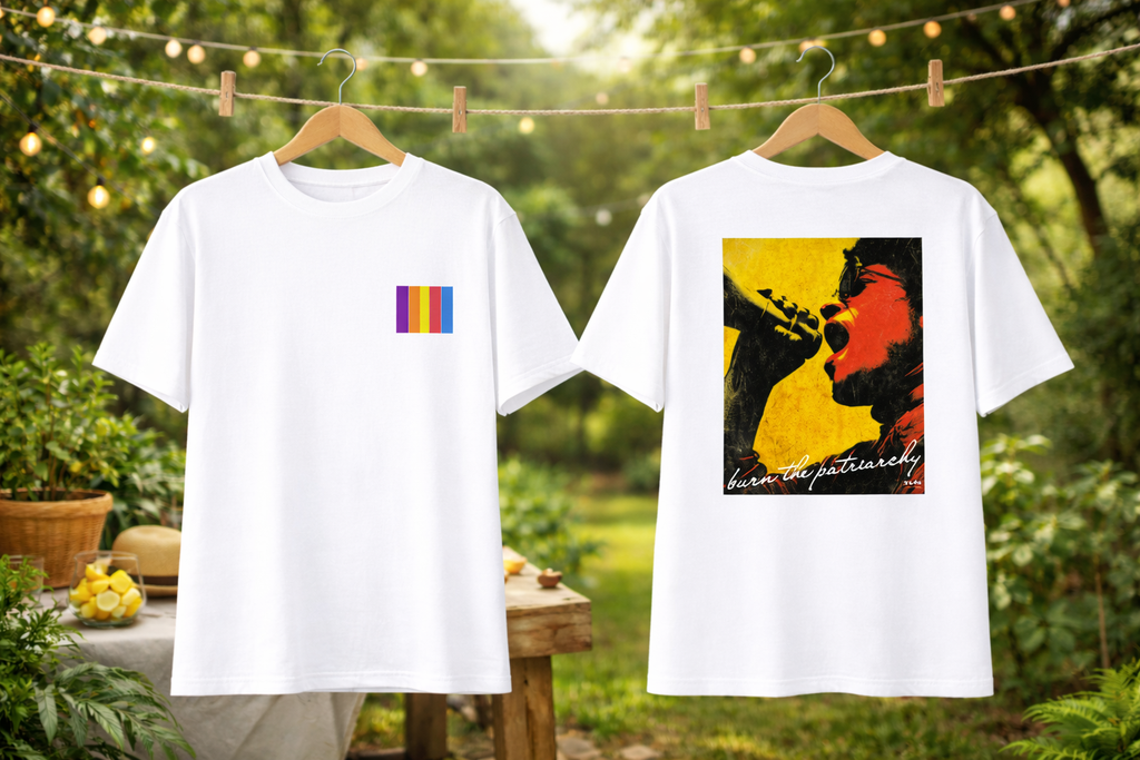 Two white t-shirts with colorful designs on hangers against a natural background.