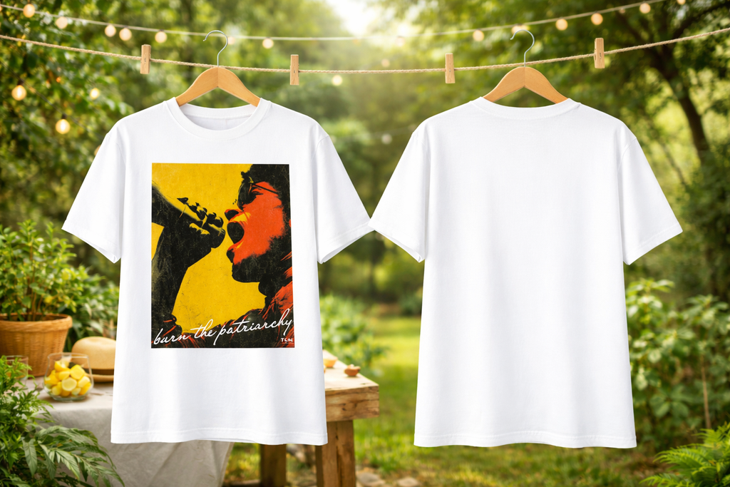 Two white t-shirts hanging outdoors, one with a graphic design on a hanger.