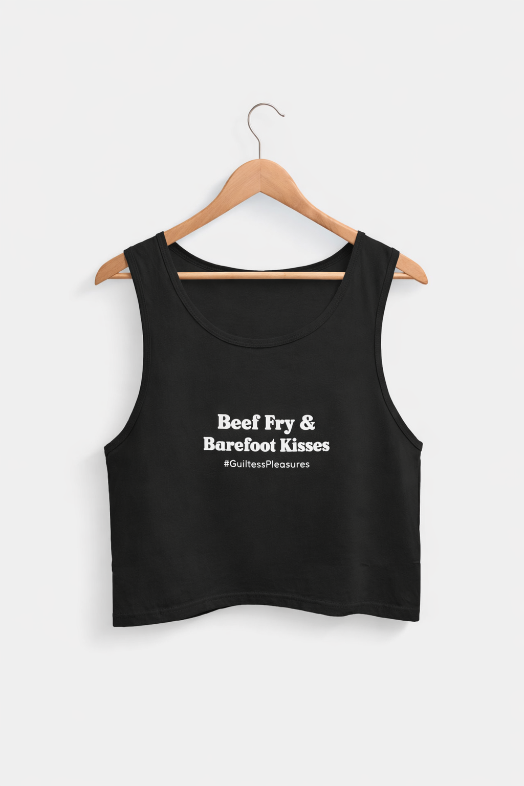 Black tank top with text on a hanger against a white background
