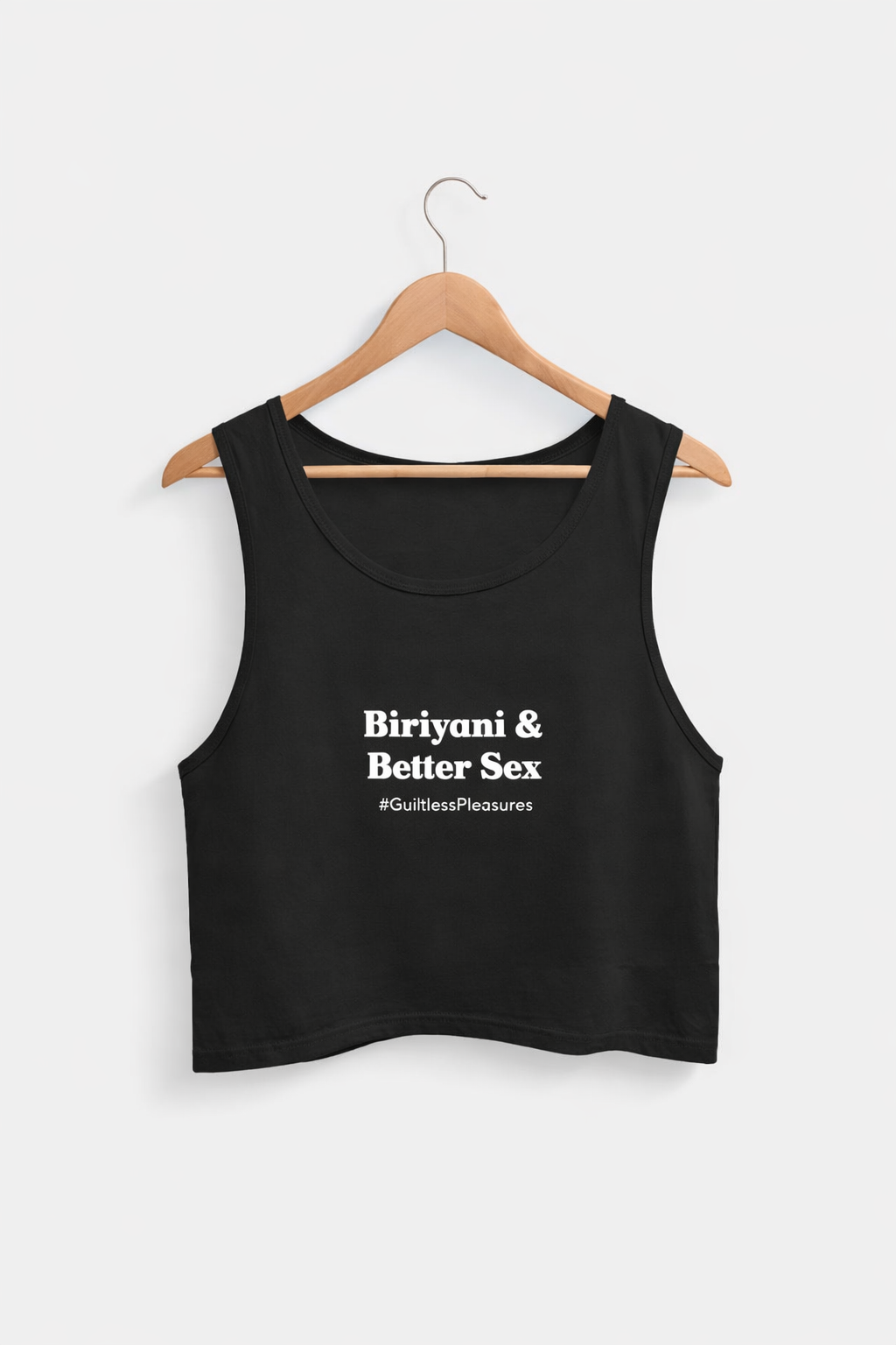 Black tank top with text on a hanger against a white background