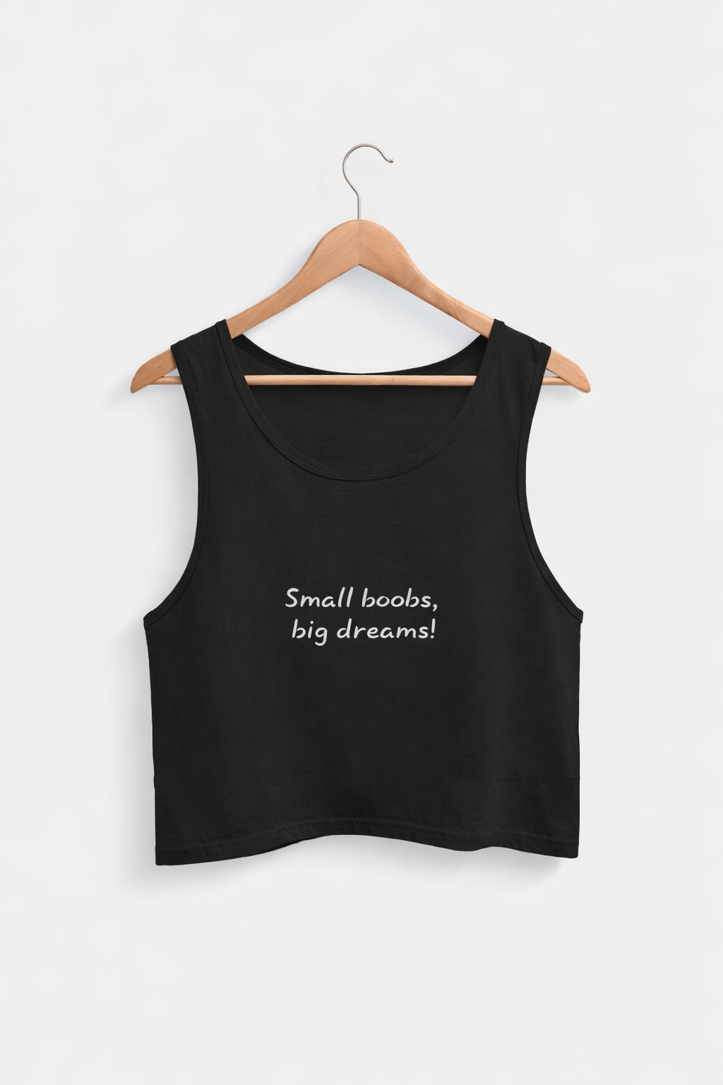 Black tank top with 'Small boobs, big dreams!' text on a hanger against a white background