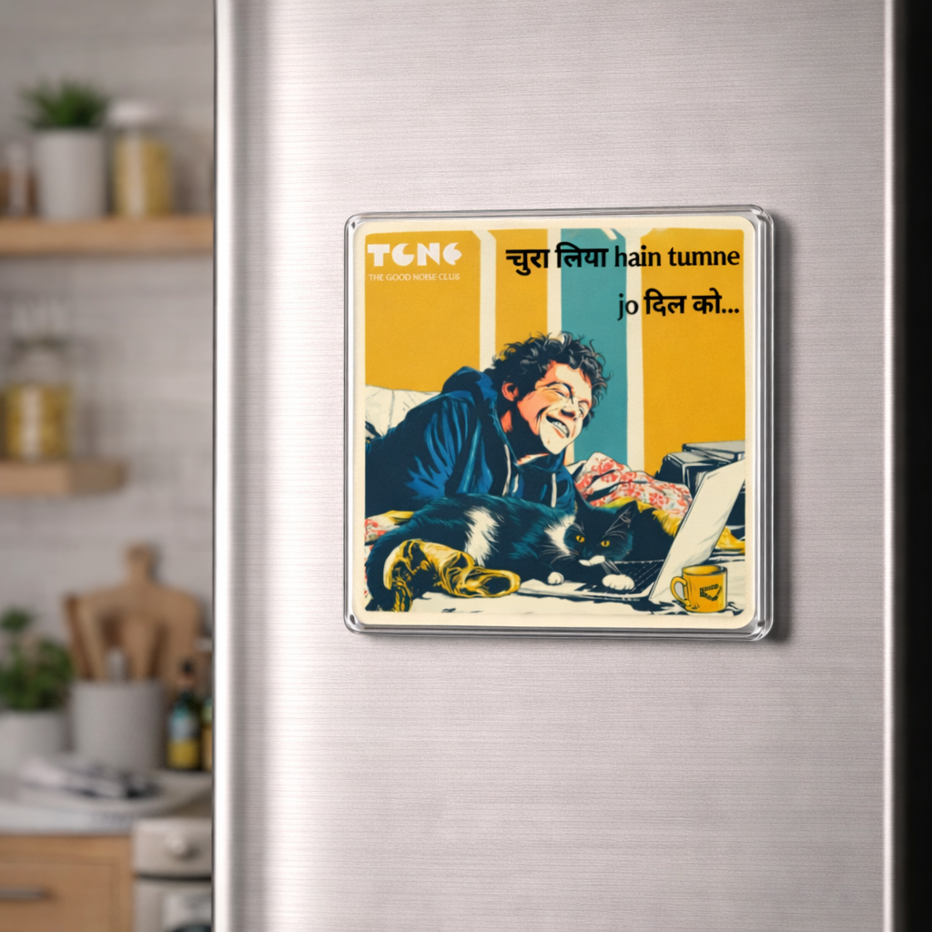 Fridge magnet with a man and cat illustration on a metallic refrigerator