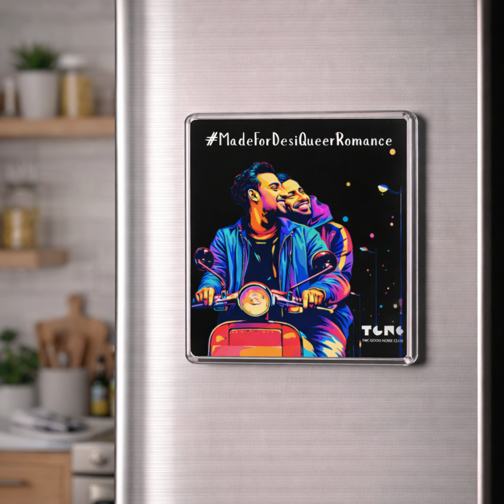 Fridge magnet with two people on a motorcycle and text '#MadeforDesiQueerRomance' attached to a refrigerator.