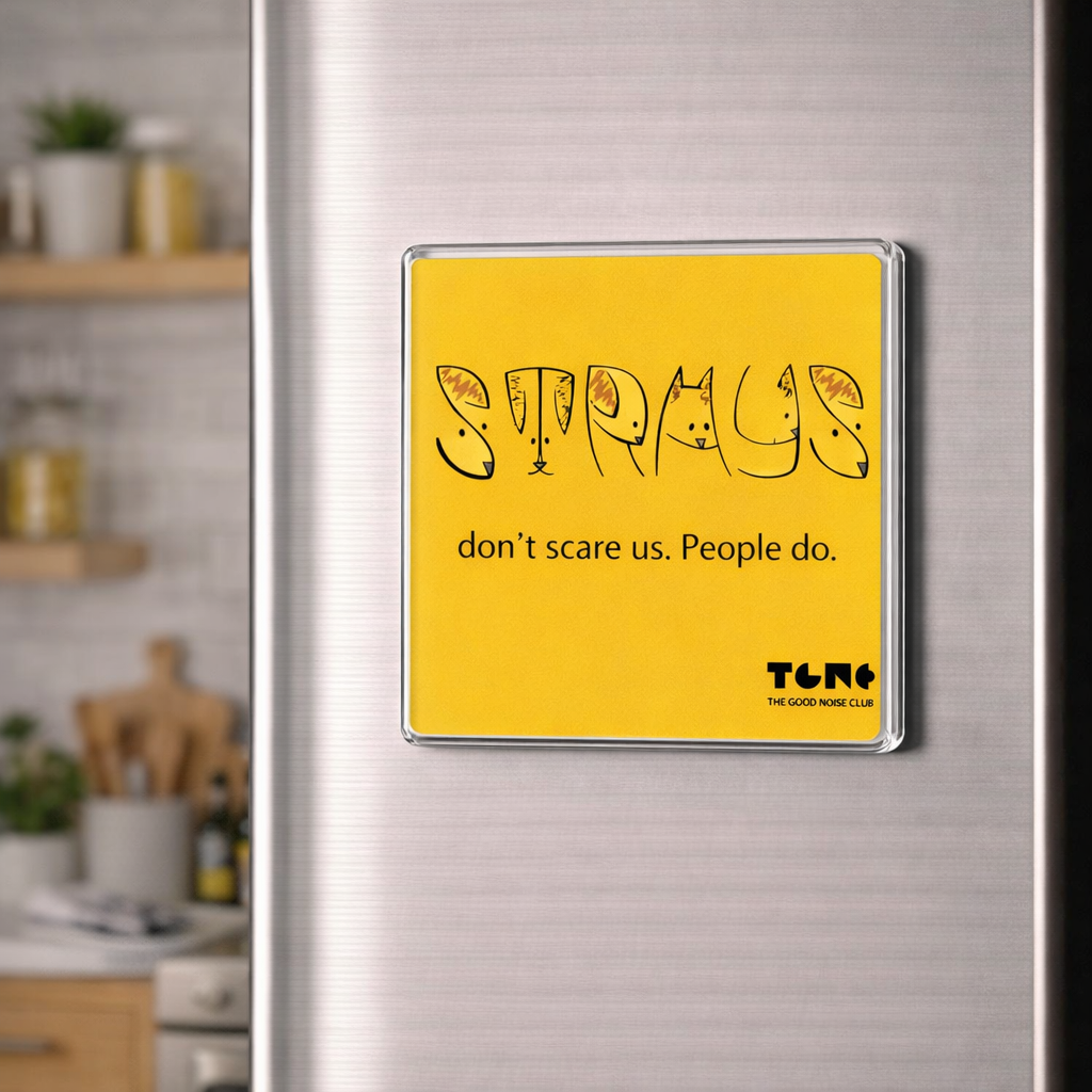Yellow magnet with text on a refrigerator in a kitchen setting