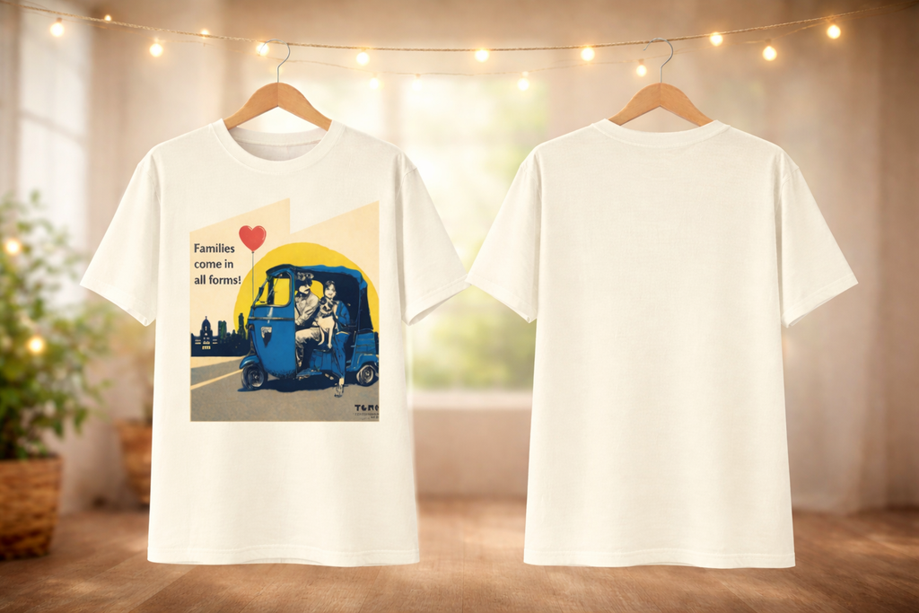 White t-shirt with a graphic design of a family in a rickshaw, displayed on hangers against a neutral background.