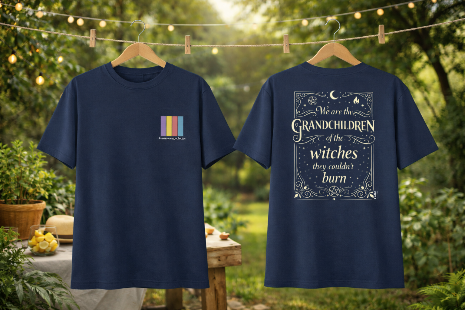 Two navy blue t-shirts with text and graphics on hangers against a natural background.