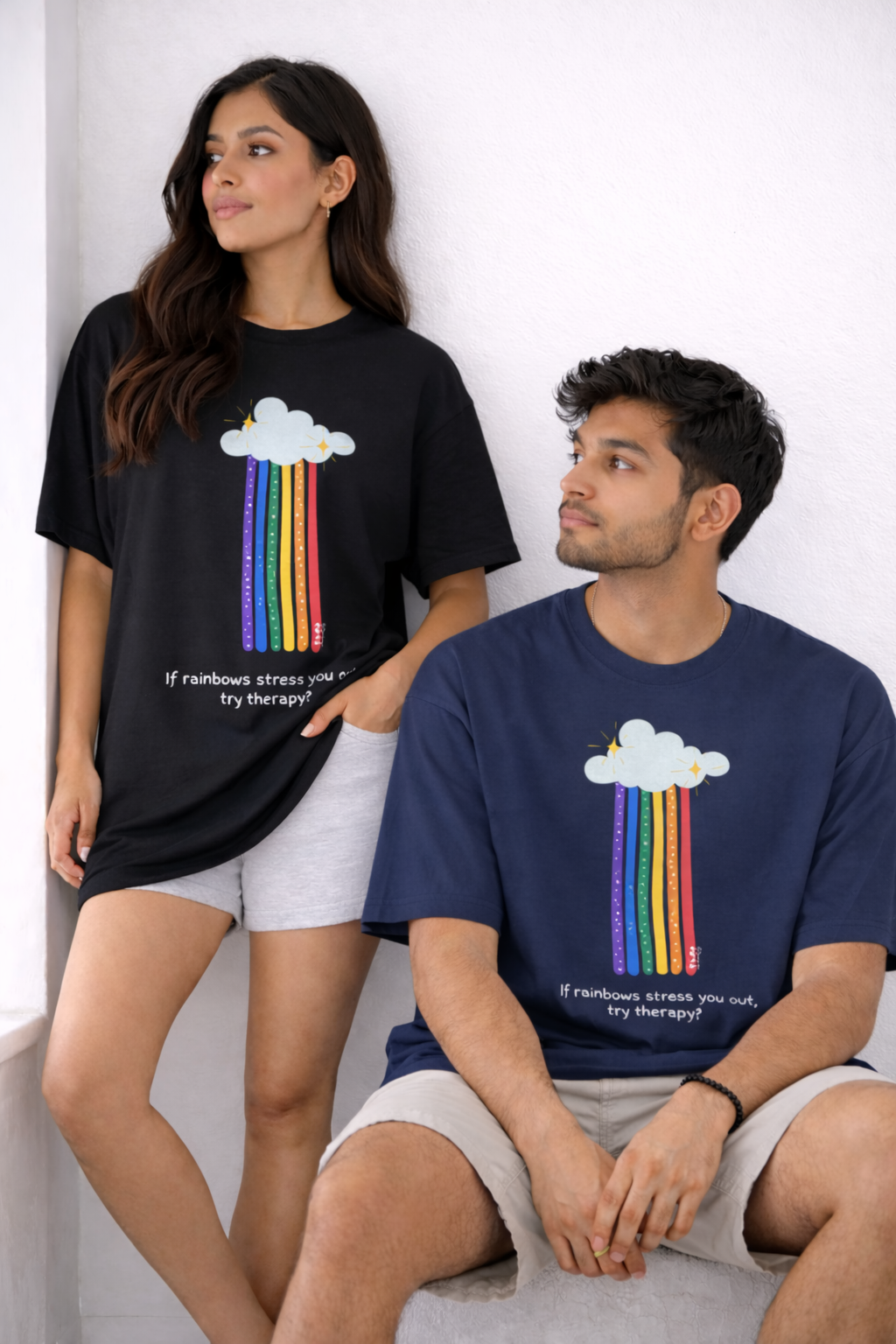 Two people wearing t-shirts with rainbow cloud designs and text.