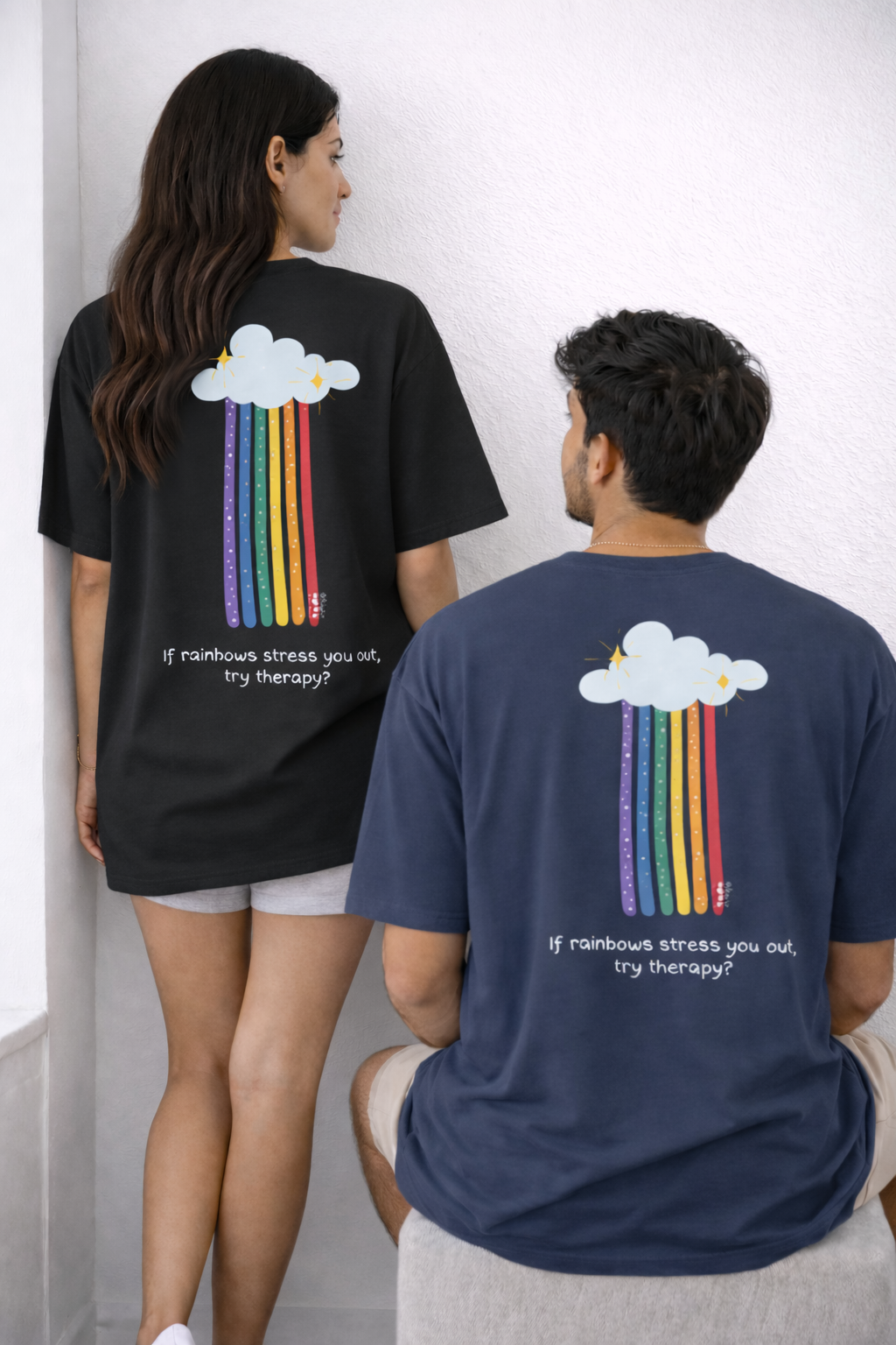 Two people wearing t-shirts with rainbow cloud designs and text.