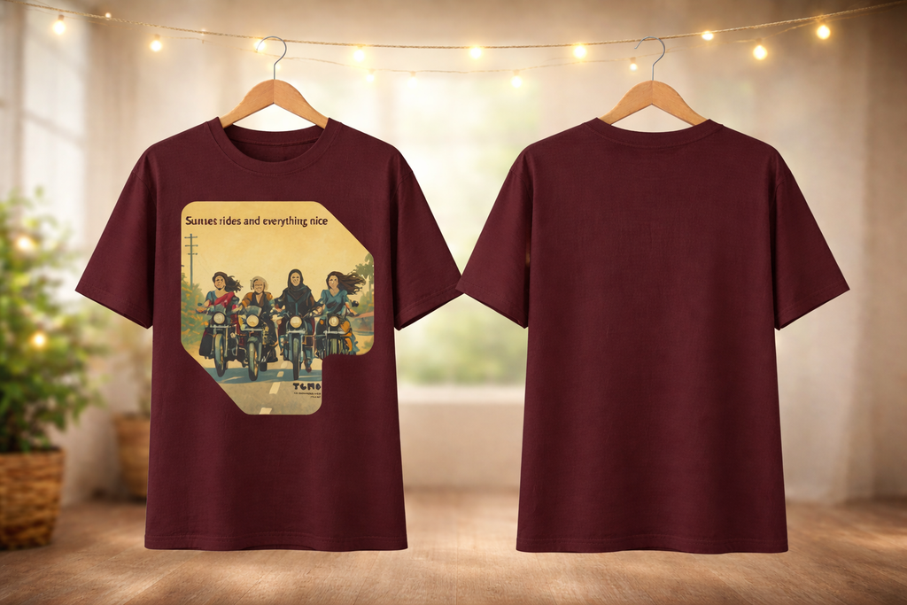 Maroon t-shirt with graphic design on a hanger against a neutral background