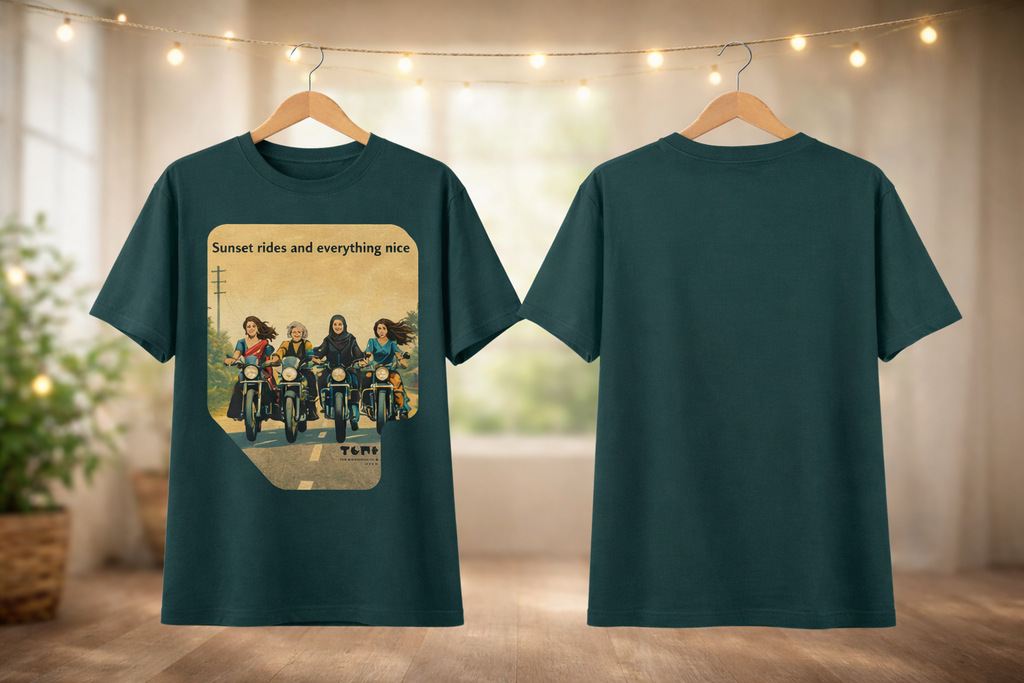 Green t-shirt with a graphic design of people on motorcycles and text 'Sunset rides and everything nice' on a hanger.