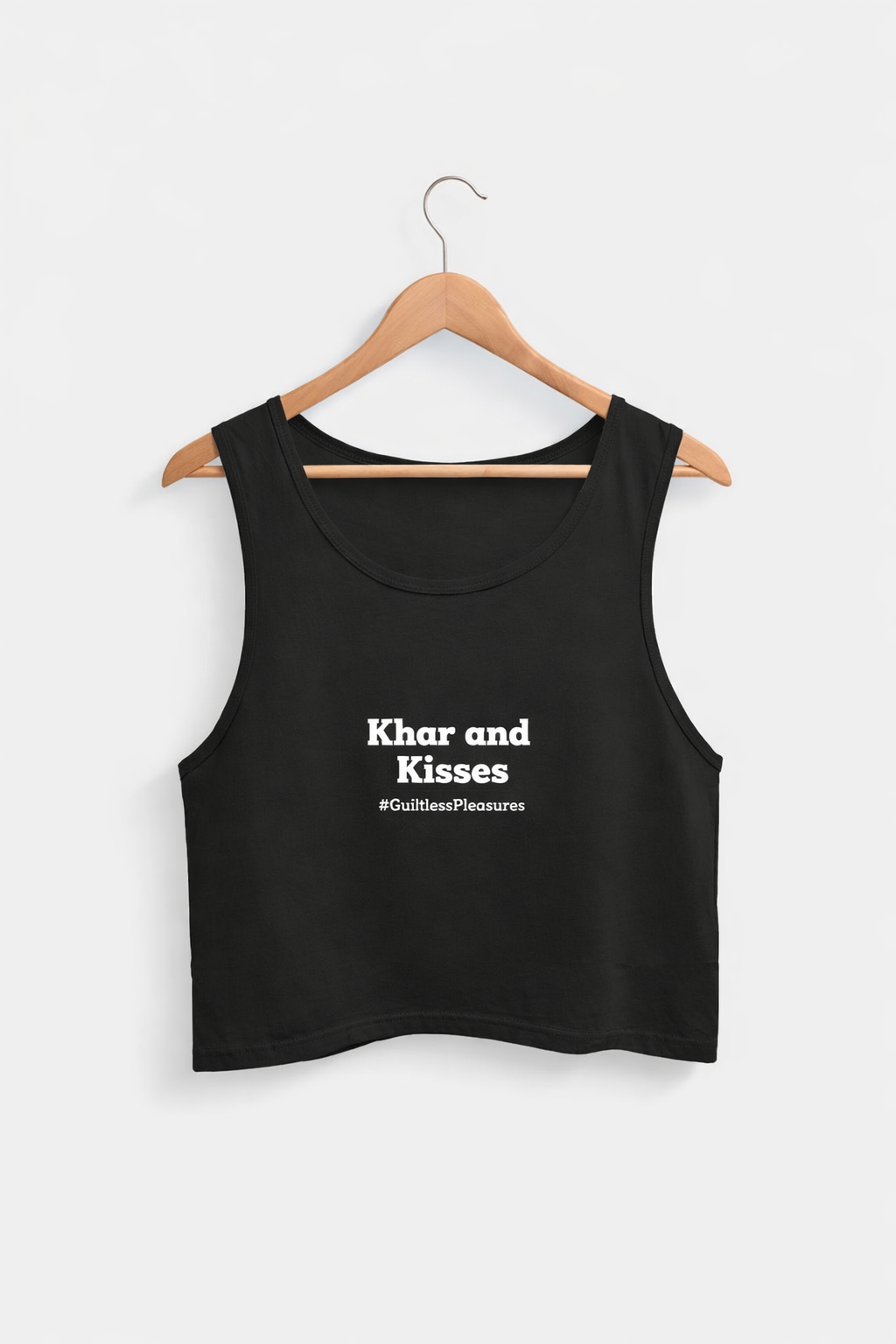 Black tank top with text on a hanger against a white background