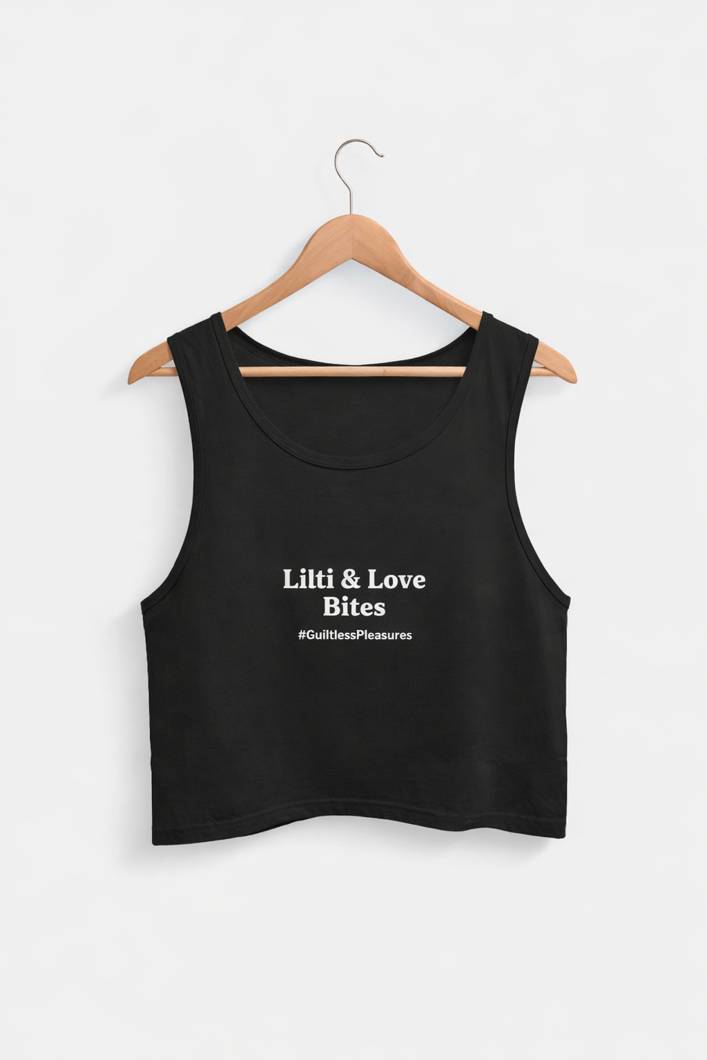 Black tank top with text on a hanger against a white background