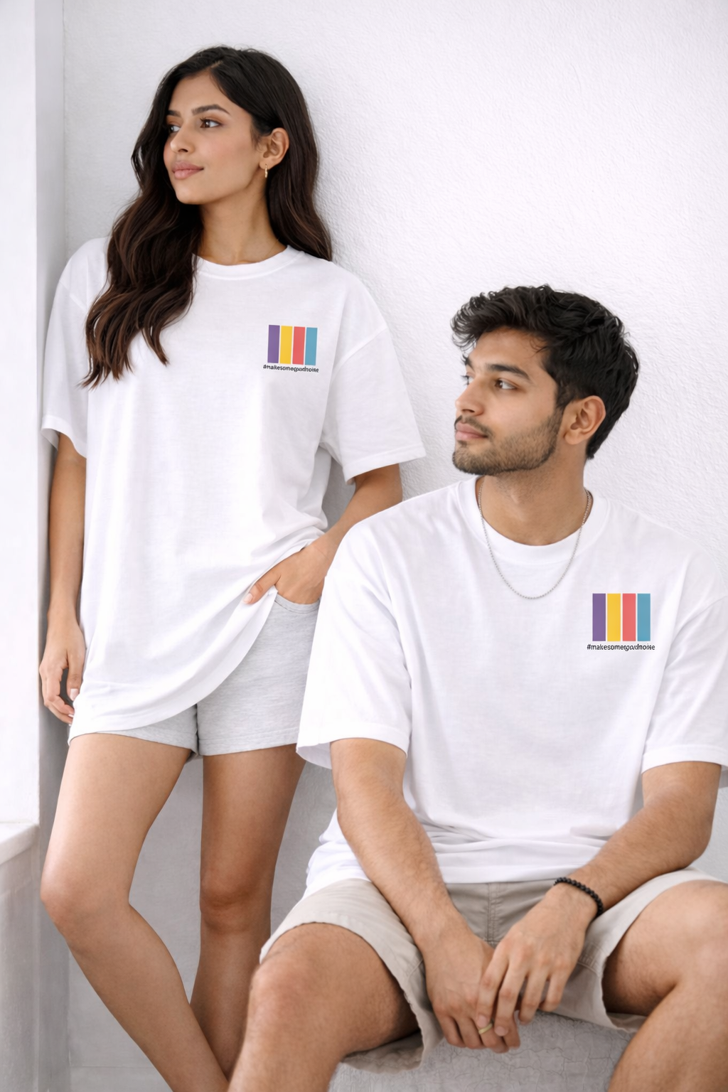Two people wearing white t-shirts with colorful logo designs on a light background