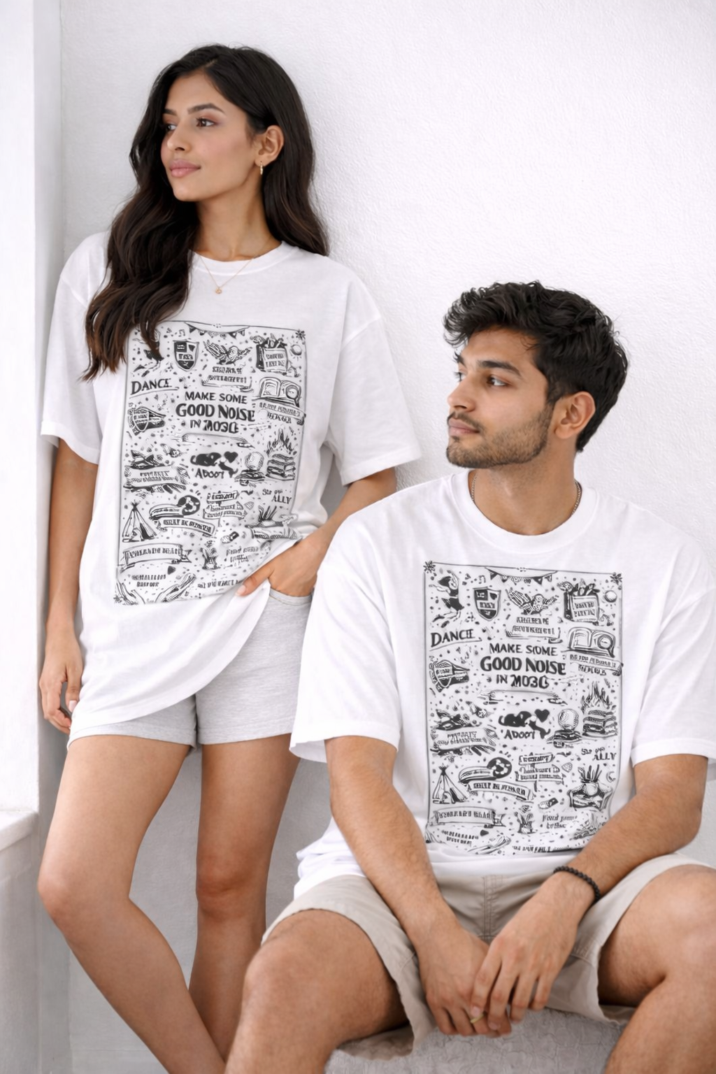 Two people wearing white t-shirts with black text and graphics on a white background