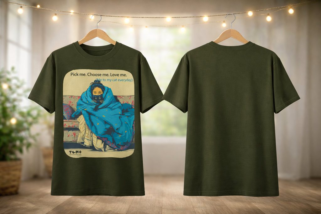 Green t-shirt with graphic design on a hanger against a neutral background