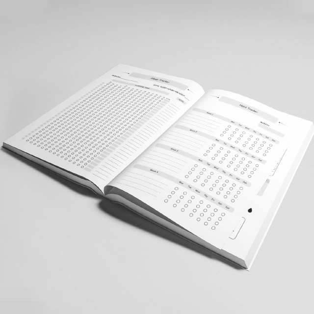 Open book with text and tables on a gray background