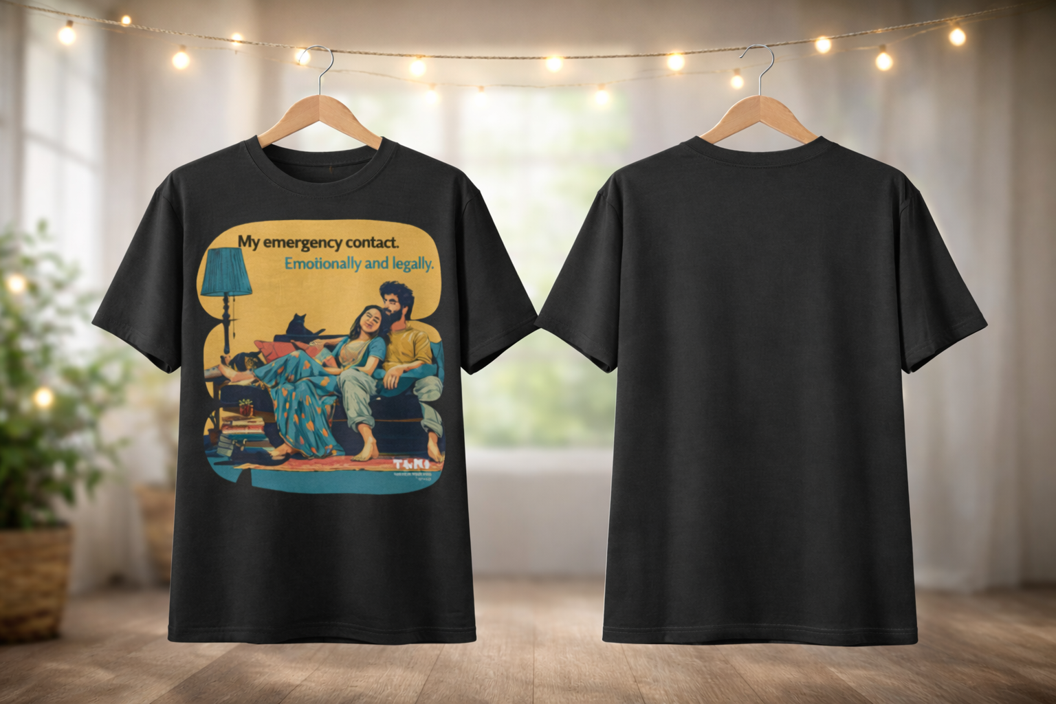 Black t-shirt with a colorful graphic design on a hanger against a neutral background.