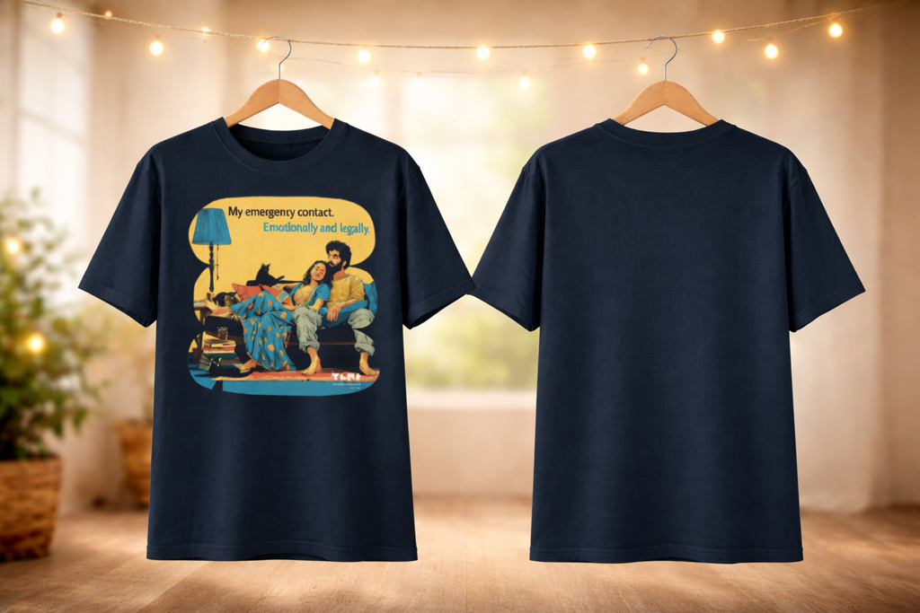 Navy blue t-shirt with a colorful graphic on a wooden hanger against a blurred indoor background.