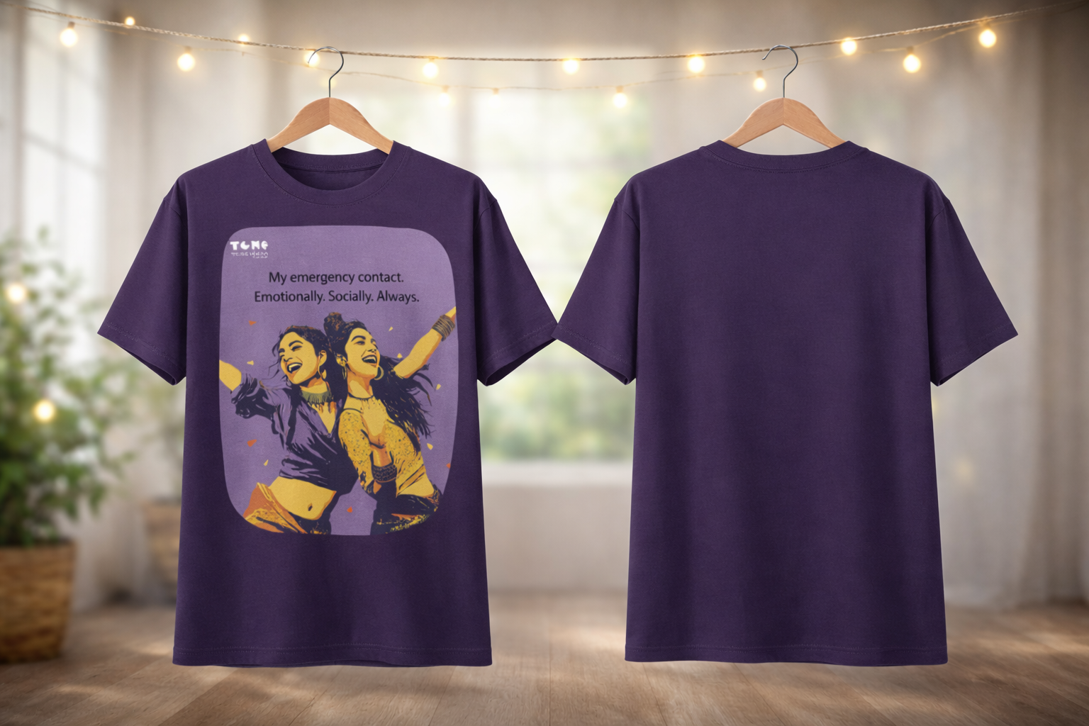 Purple t-shirt with graphic design on a hanger against a neutral background