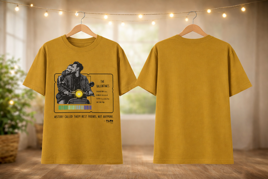 Yellow t-shirt with graphic design on a hanger against a neutral background