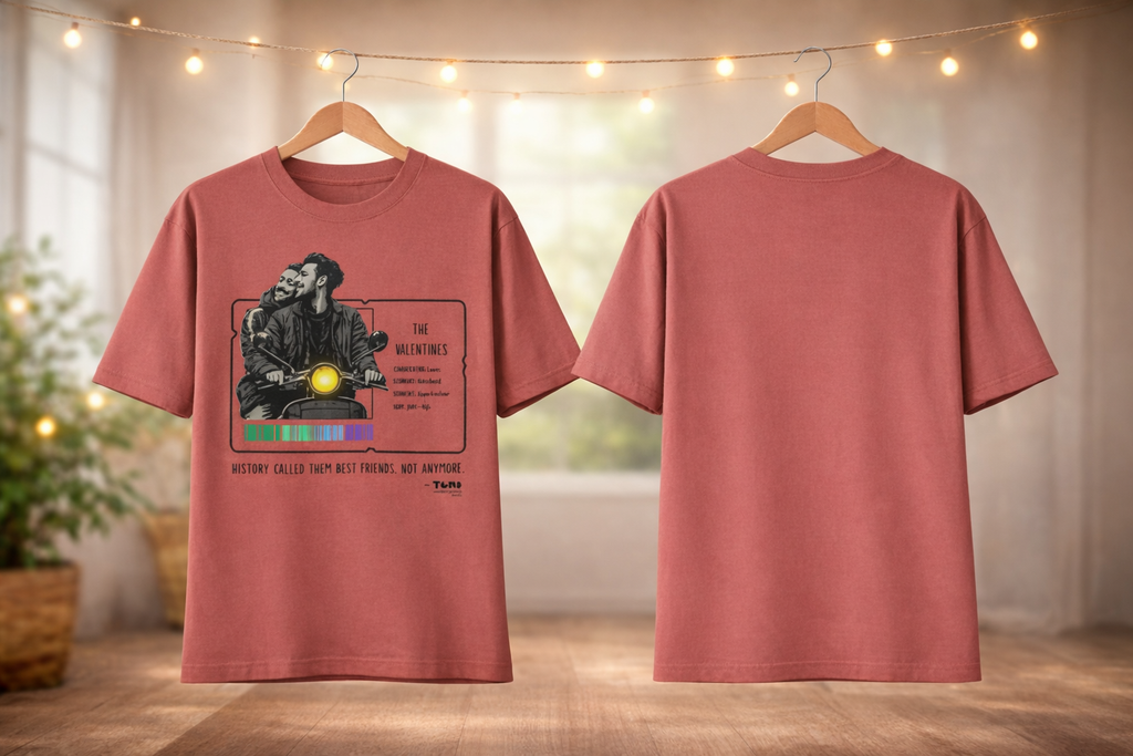 Red t-shirt with graphic design on a wooden floor with blurred lights in the background