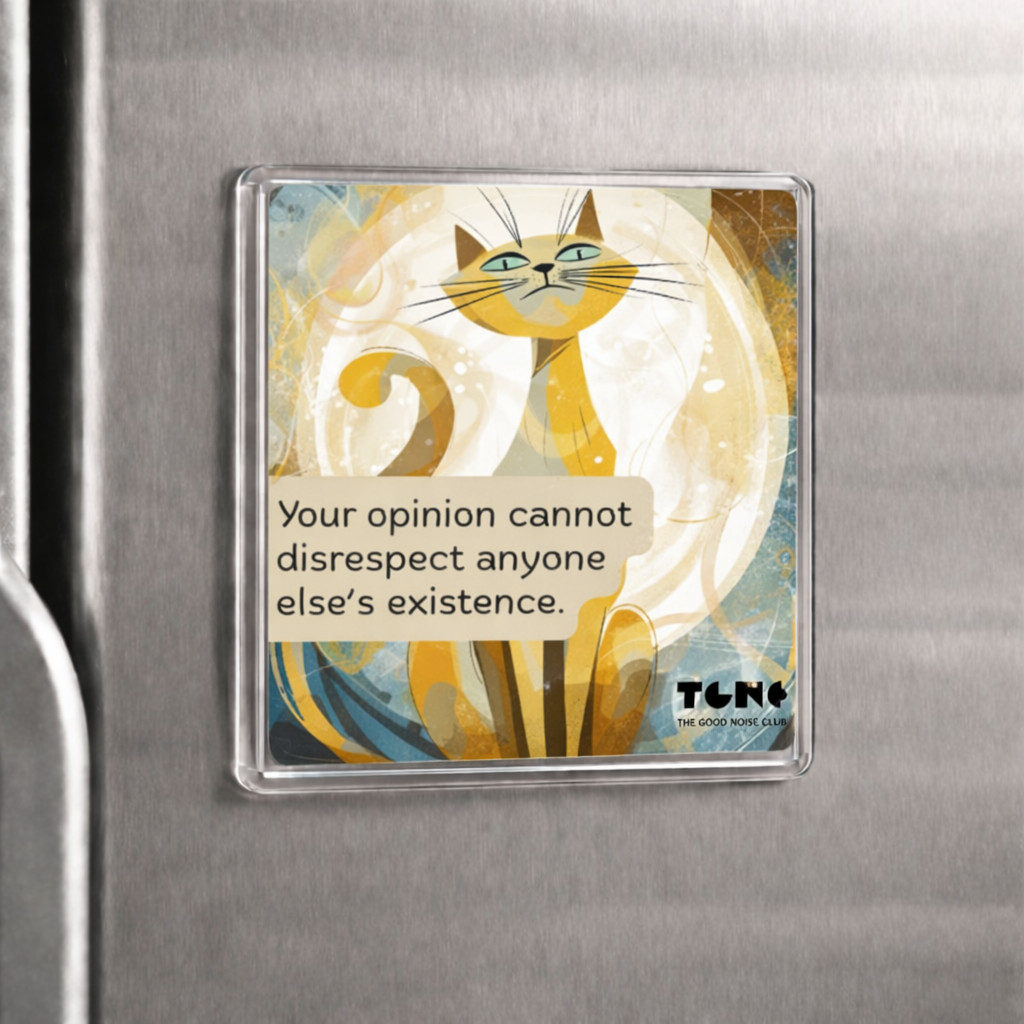 Fridge magnet with a cat illustration and text on a metallic surface